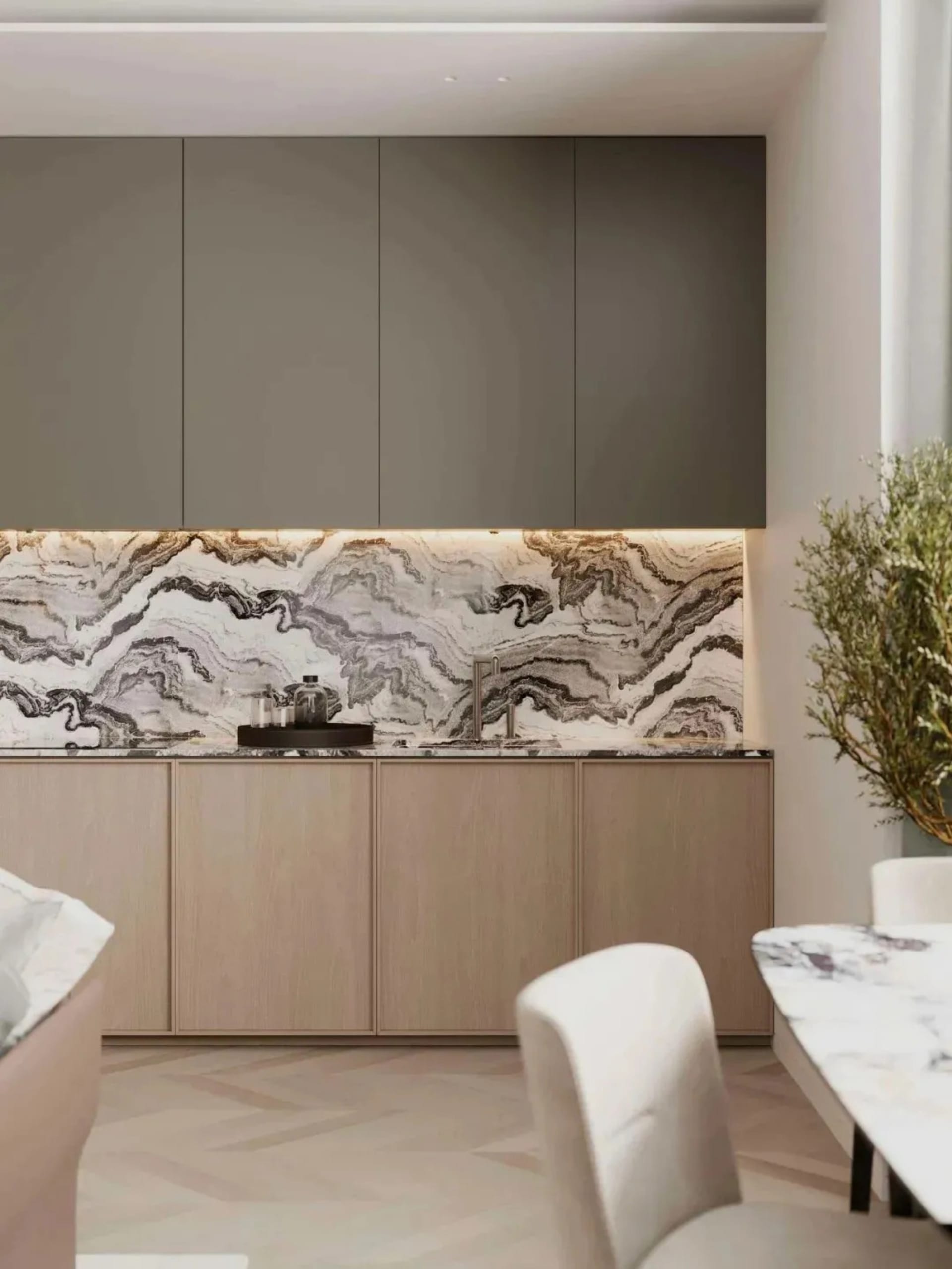 Modern kitchen with marble countertops and backsplash, wooden cabinets, and white seating.