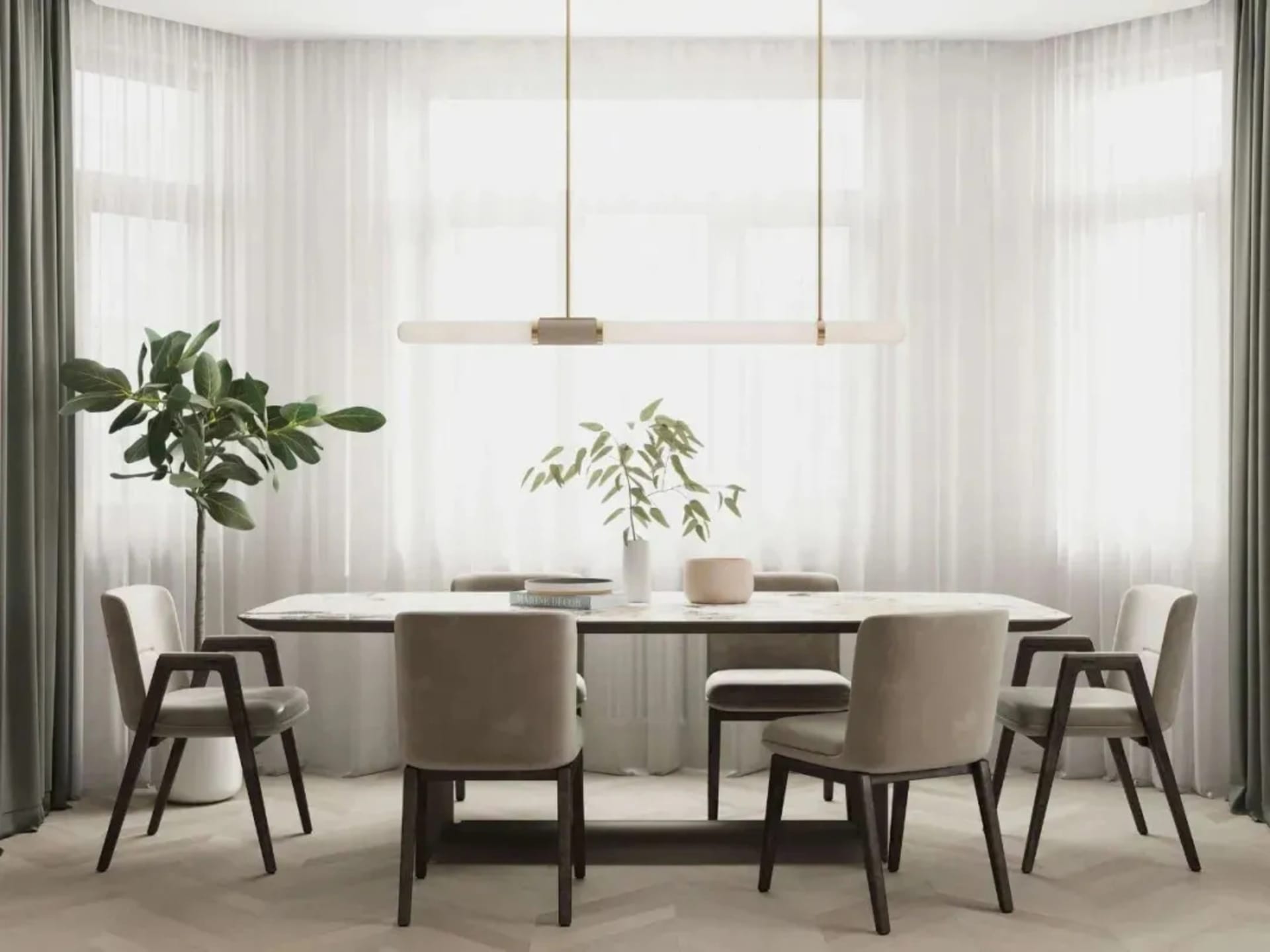 Modern minimalist dining room with gray fabric chairs and white marble table, featuring a long linear light fixture and green