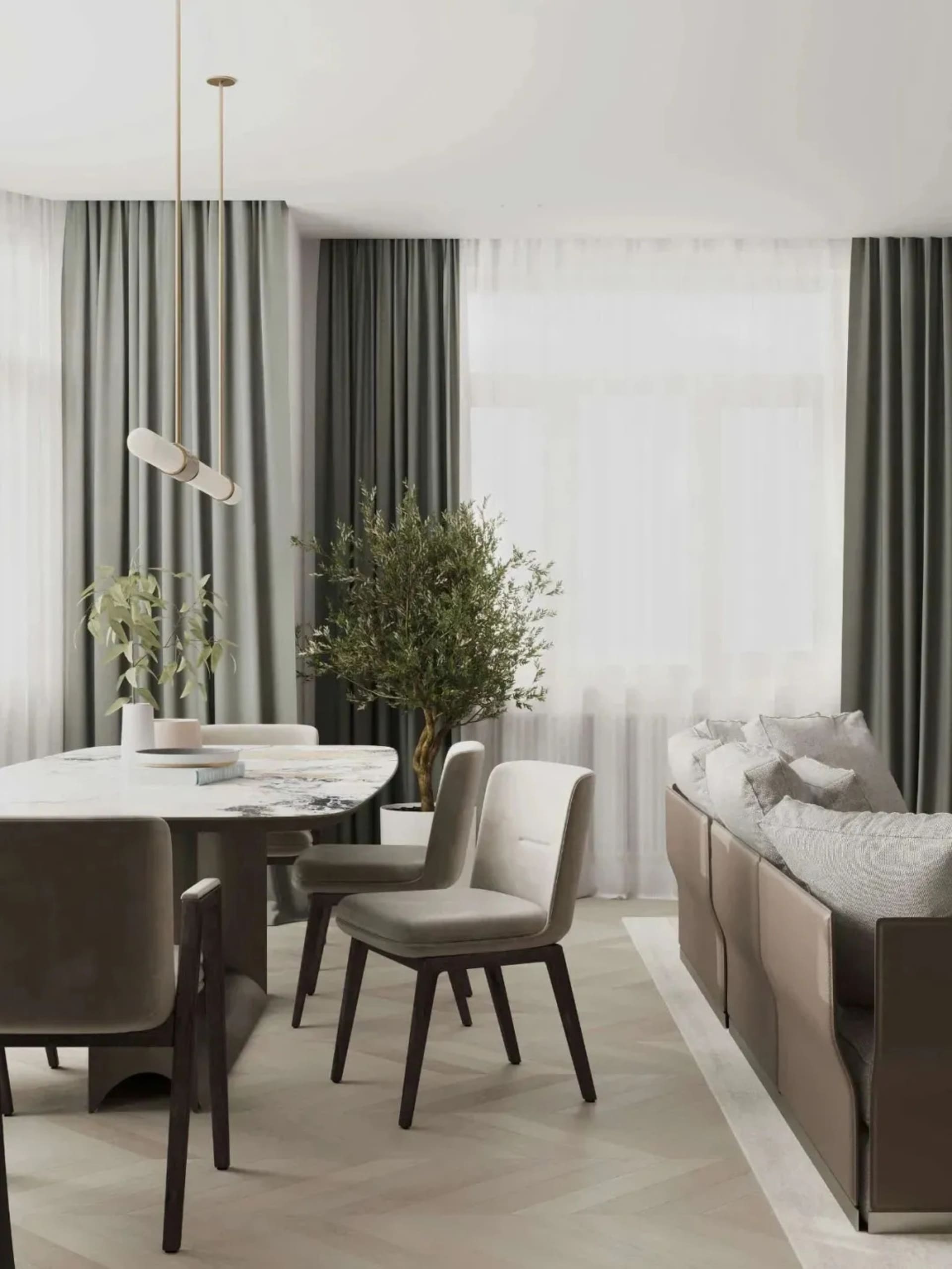 Contemporary living room featuring a marble coffee table surrounded by upholstered chairs and a modern sofa with pillows.