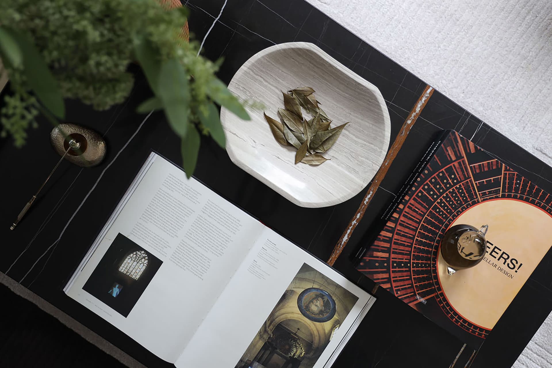 A minimalist coffee table setting with marble surface and decorative elements.