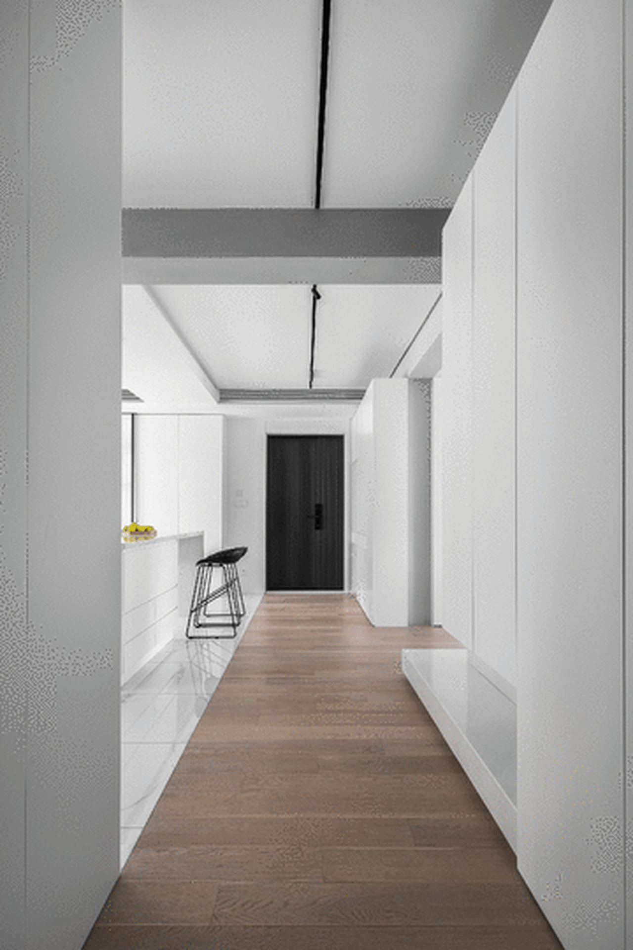Modern white corridor interior with minimalistic design and wooden flooring.