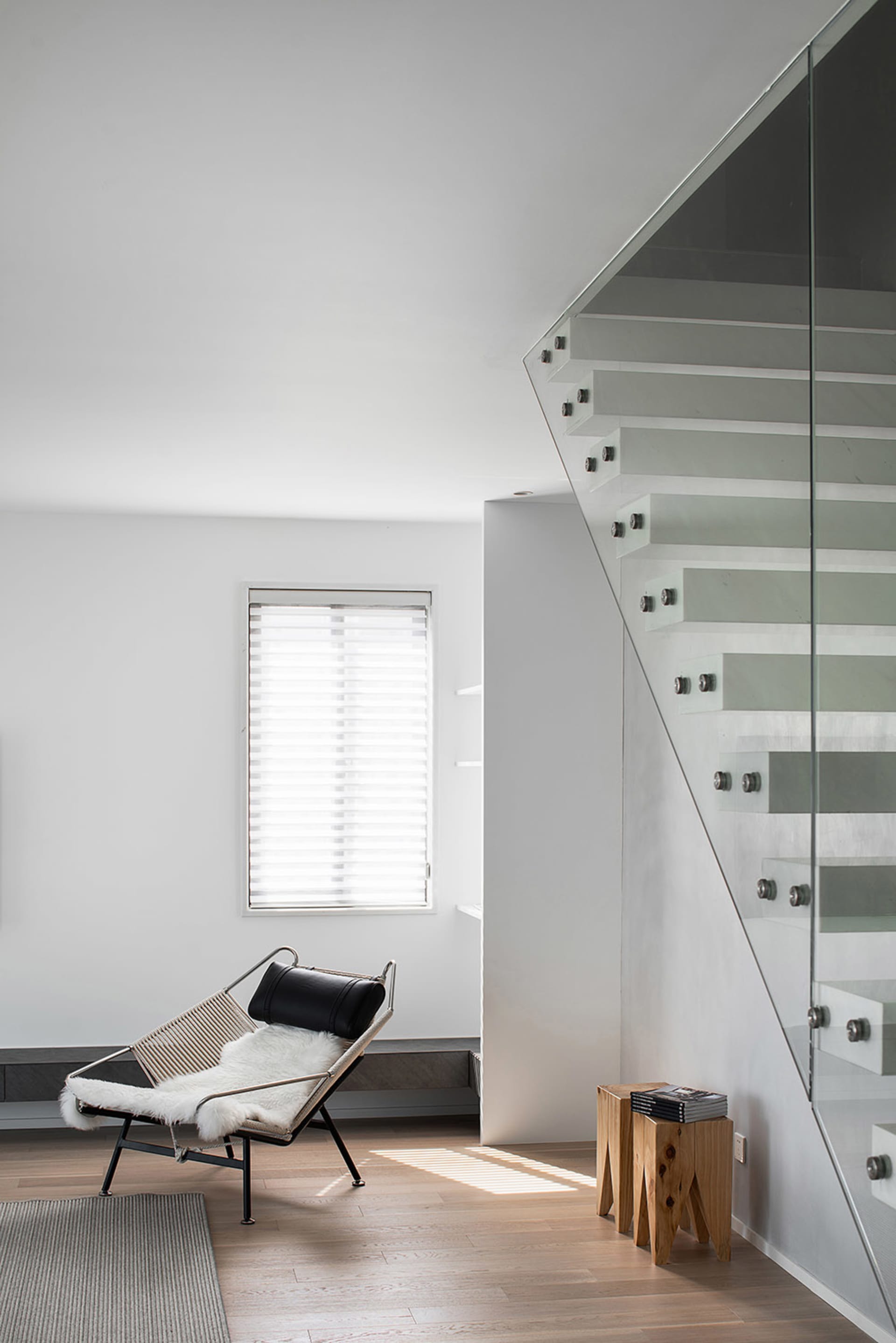 Modern interior featuring a glass and steel staircase.