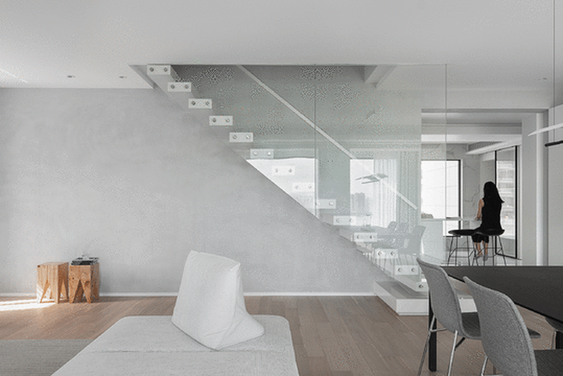 Modern living room featuring a glass staircase