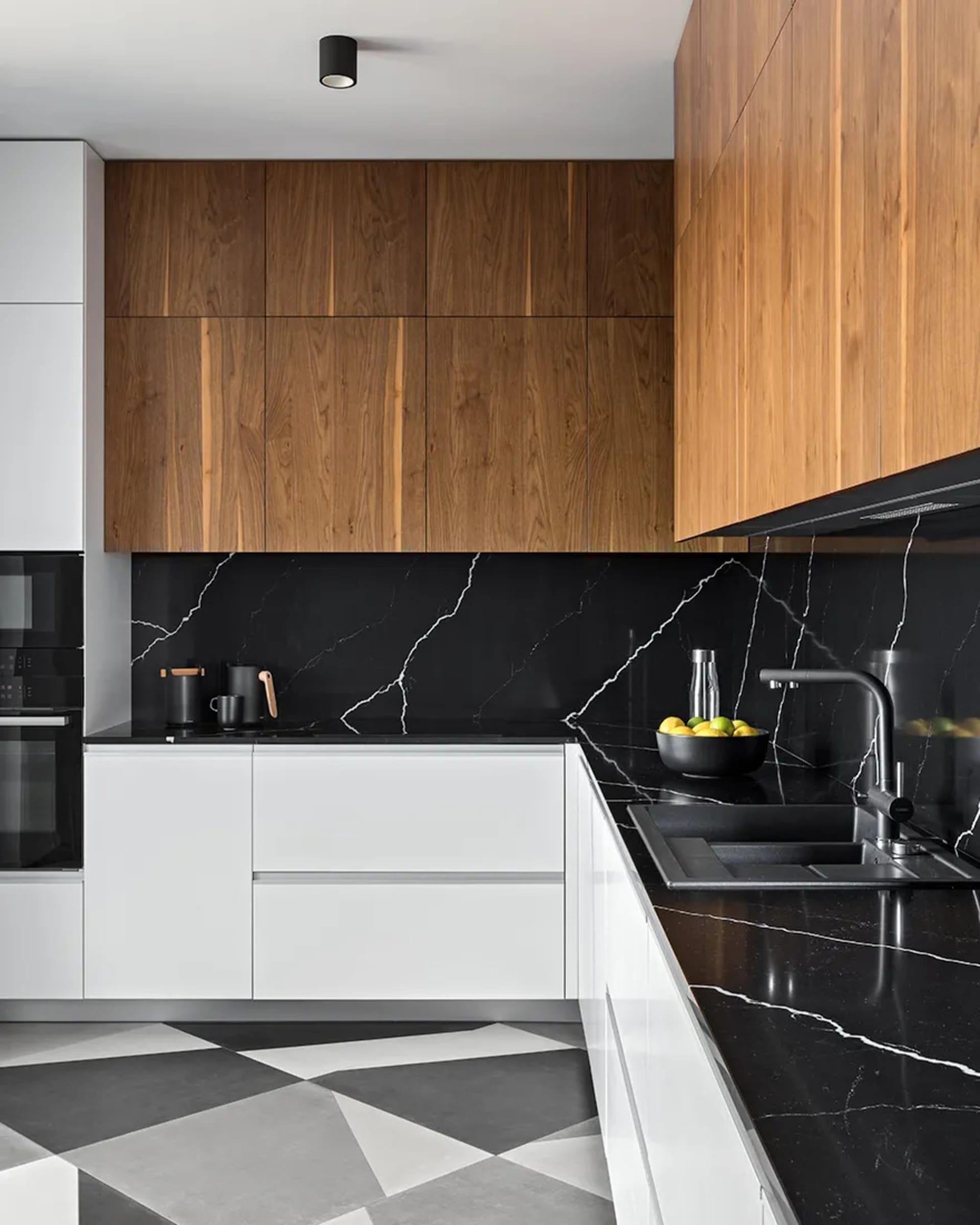 Modern kitchen with black marble countertops and wood cabinets