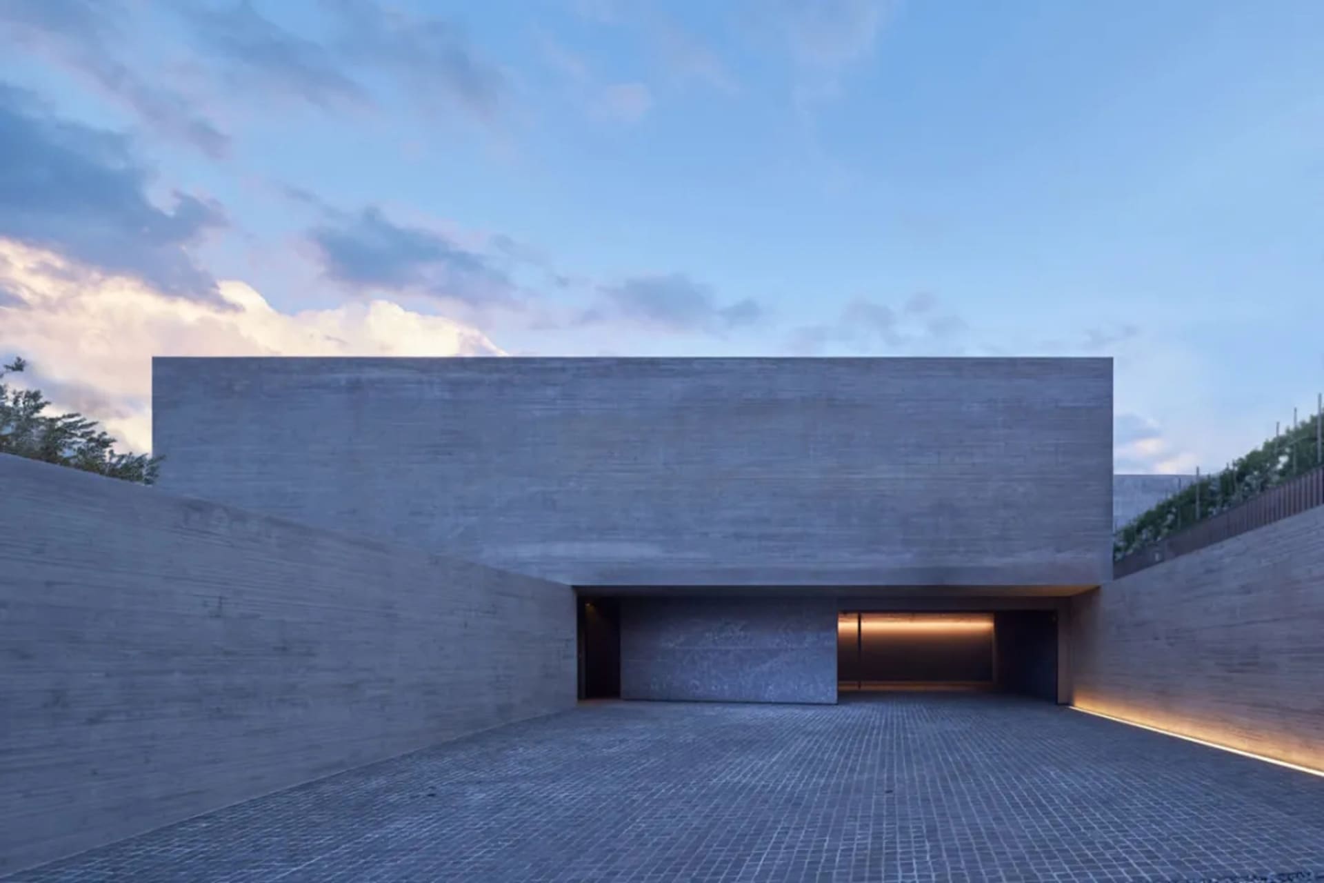 A modern concrete monument with illuminated entrance