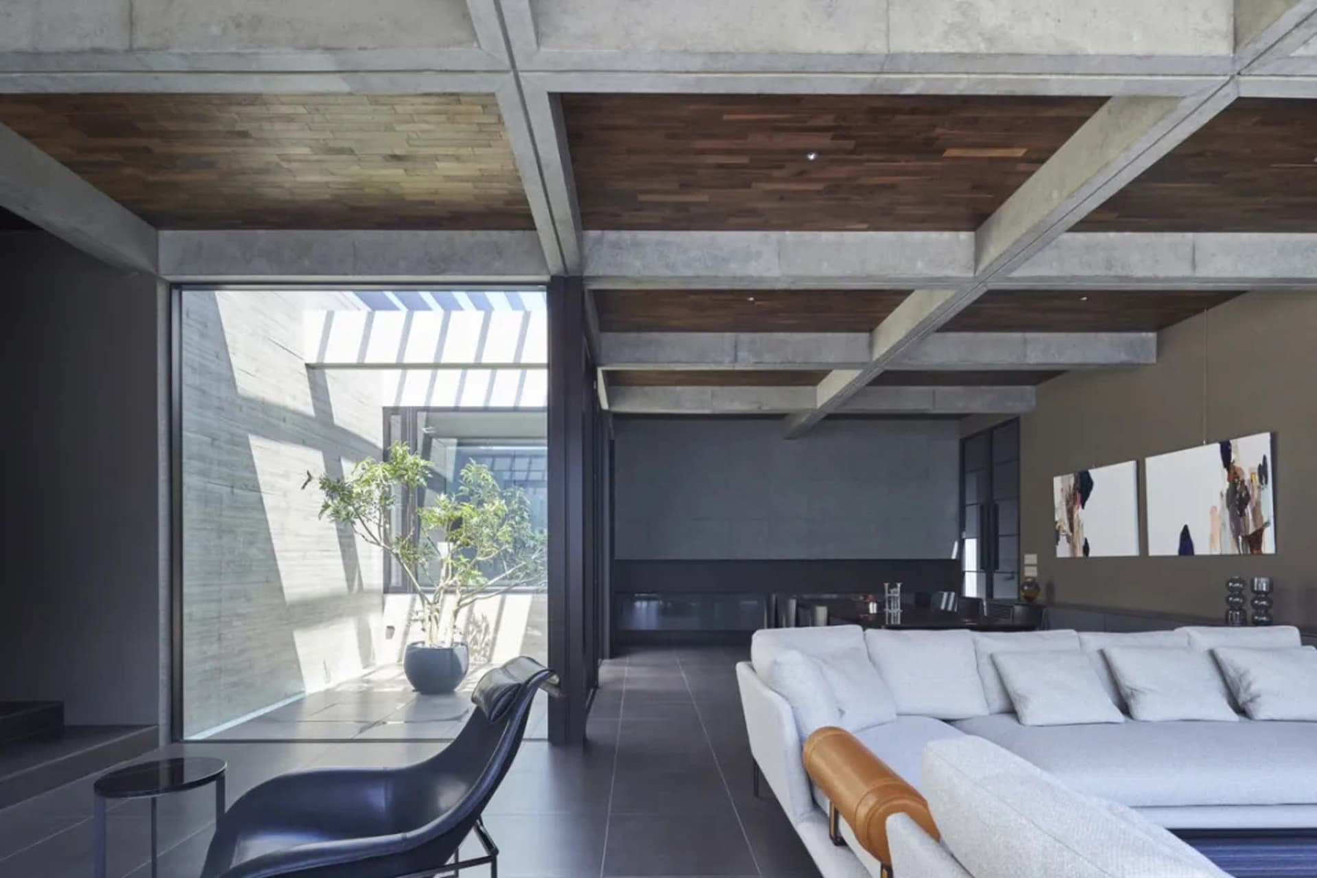 A modern living room featuring concrete and wooden elements.