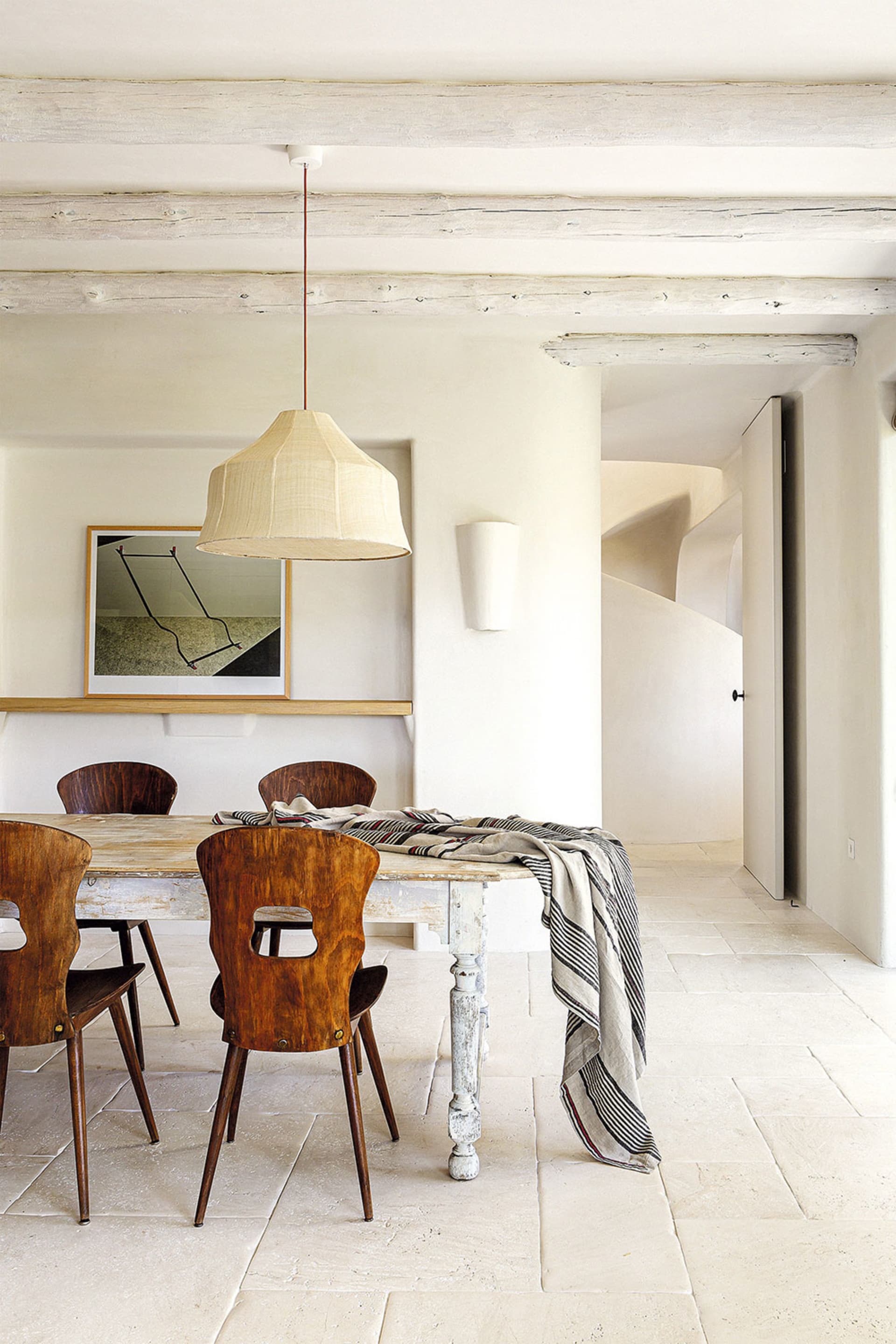 Industrial dining room featuring wooden furniture with a pendant light hanging above