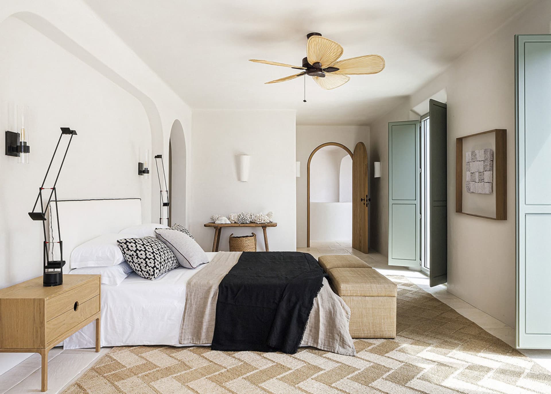 A minimalist bedroom with neutral-toned furniture and decor.