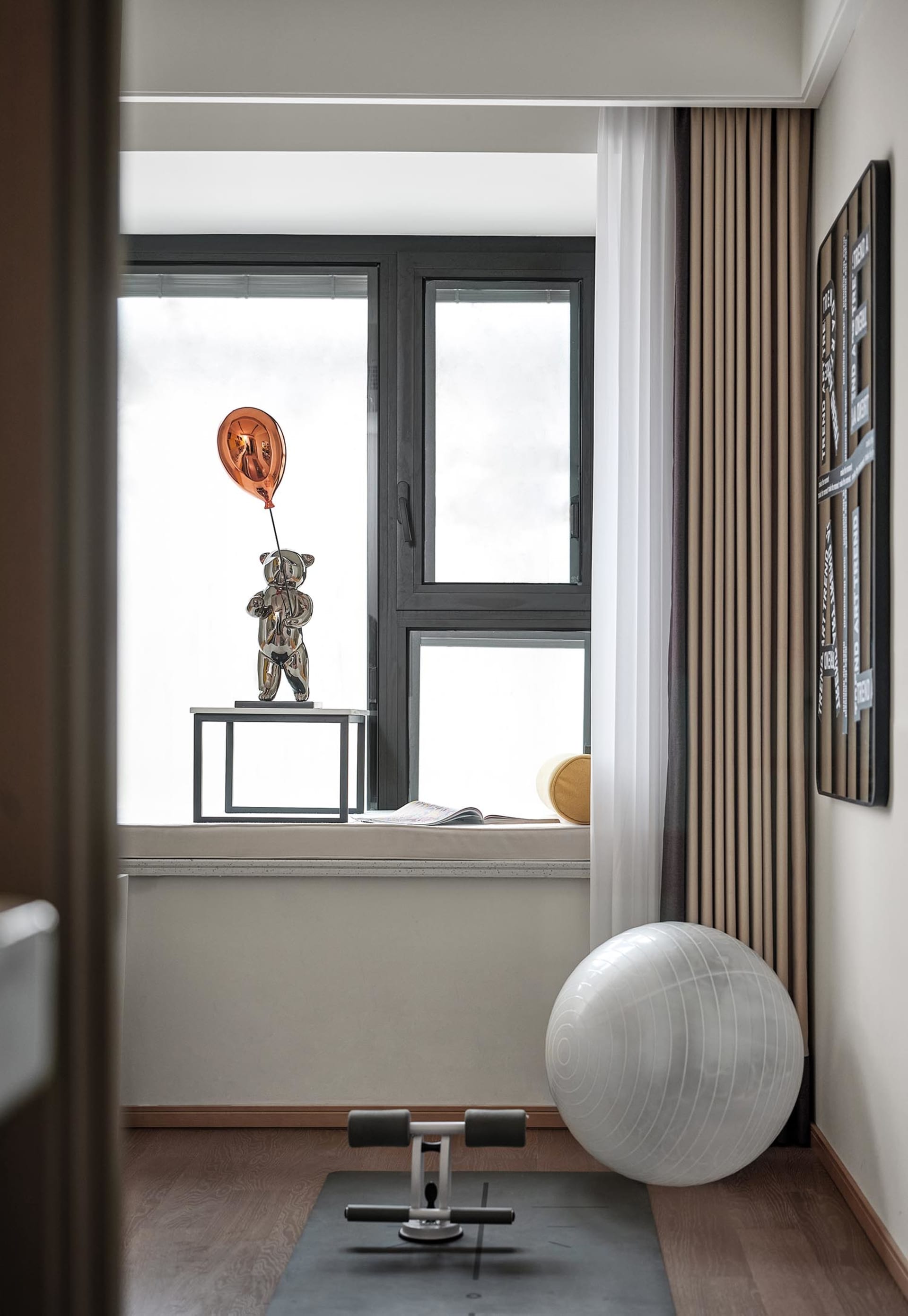 A modern home office space featuring a sleek, minimalist design with a contemporary aesthetic, featuring a workout area with 
