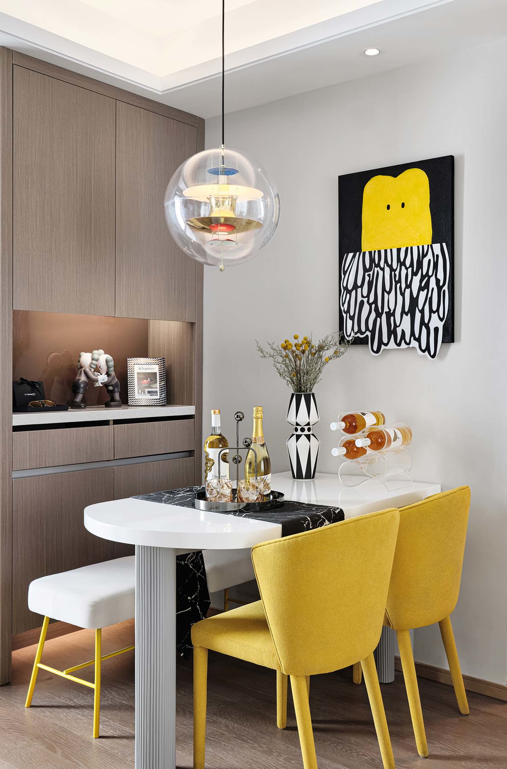 Contemporary dining room with minimalist furniture, yellow chairs, and a sleek, white table.