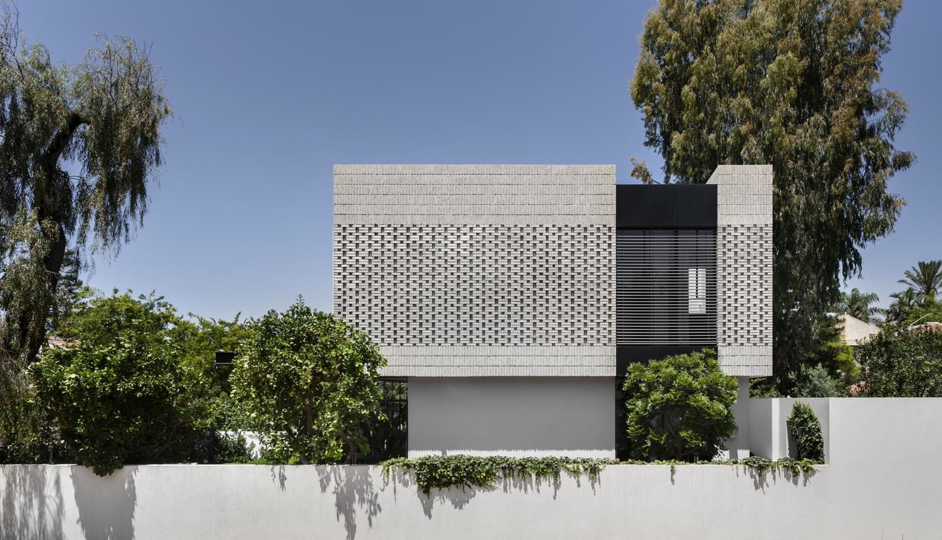 Modern residential building featuring brick cladding and minimalist design