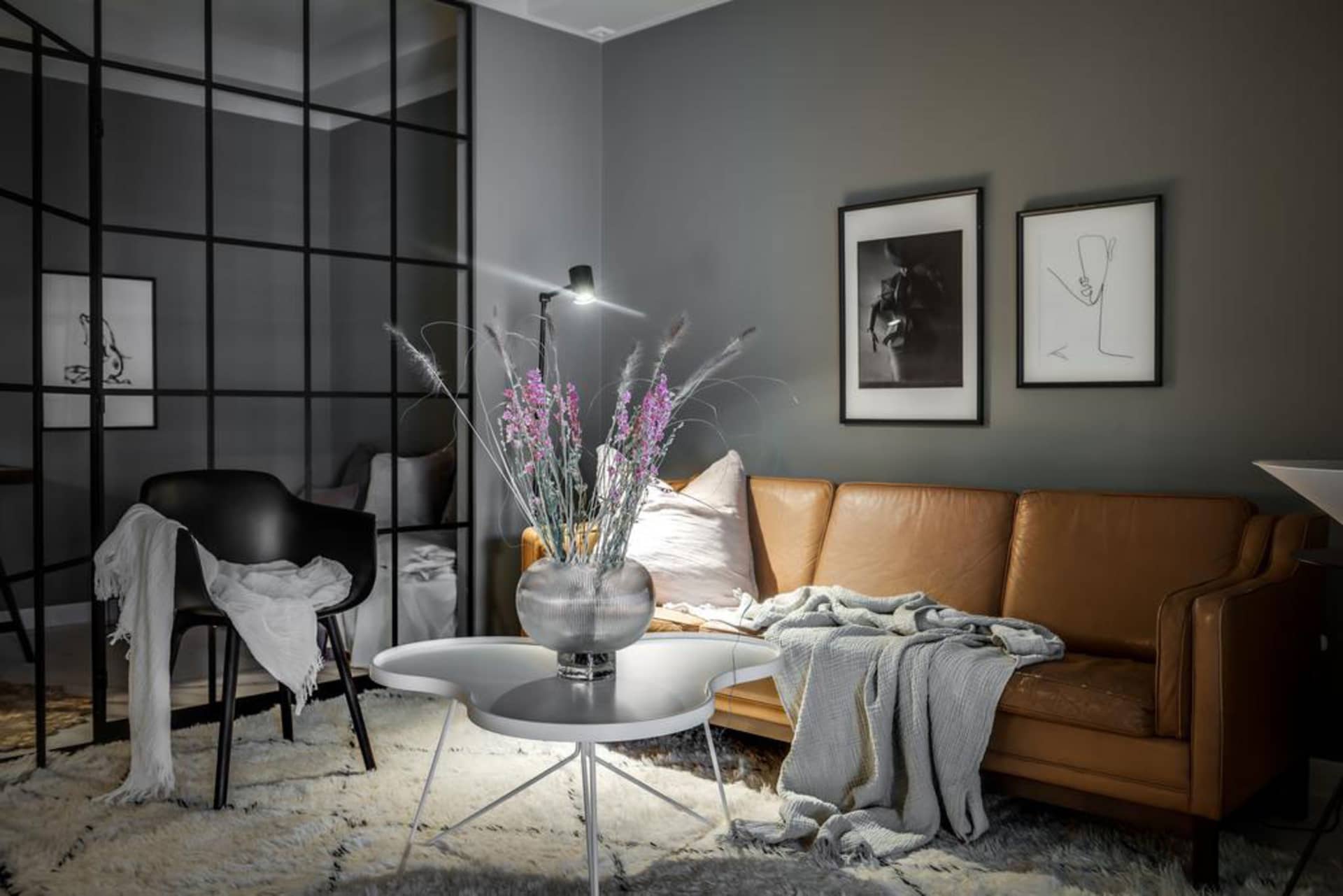 A modern industrial residential interior with steel and leather elements.