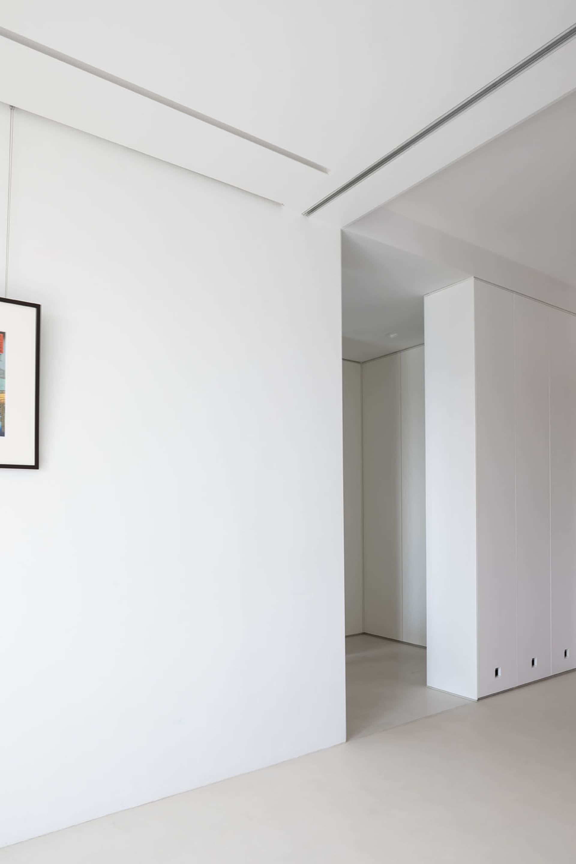 Minimalist bedroom with white walls and furniture