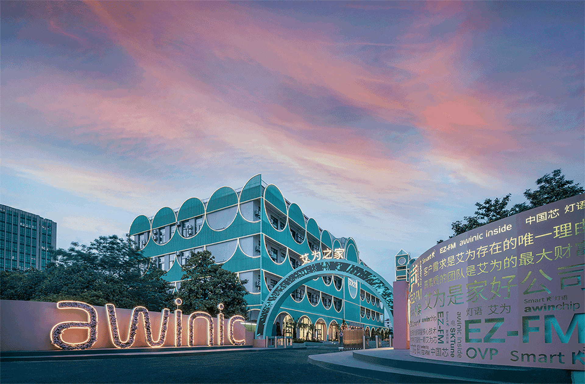Modern office building with distinctive blue exterior cladding and branded signpost