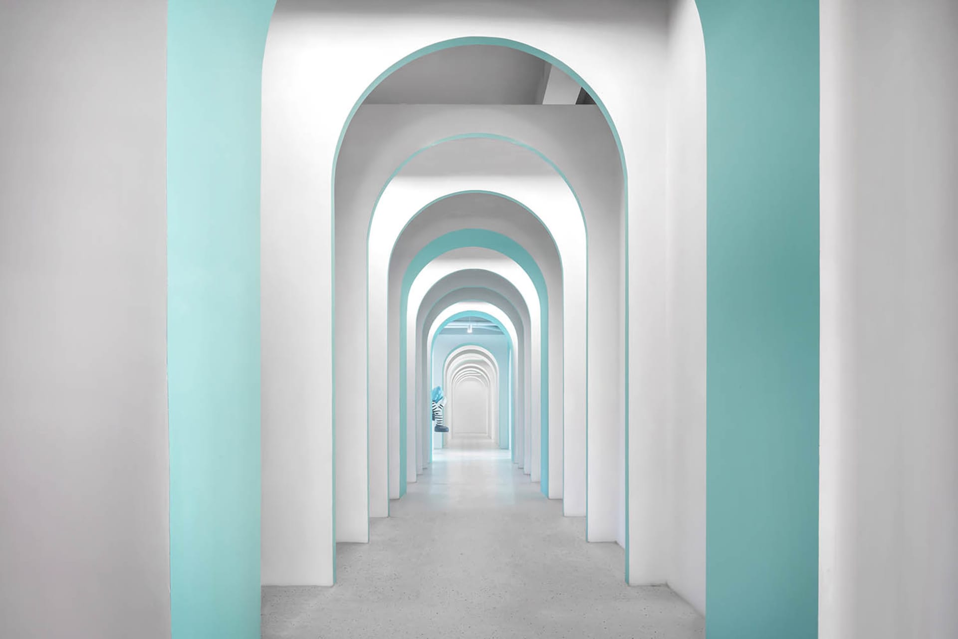 Modern architectural interior designed with white and blue accents, showcasing contemporary design elements.
