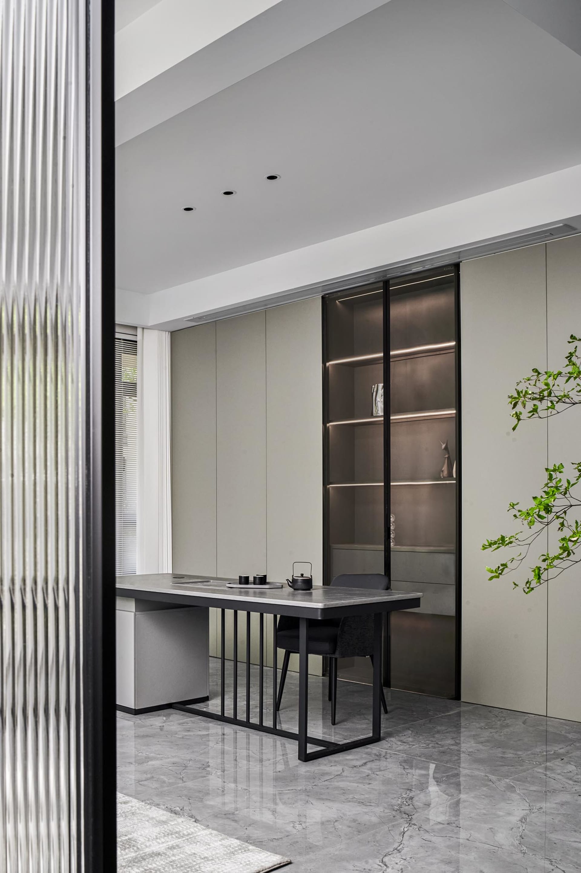 Industrial home office with modern black accents, featuring a sleek desk, leather chair, and minimalist design.