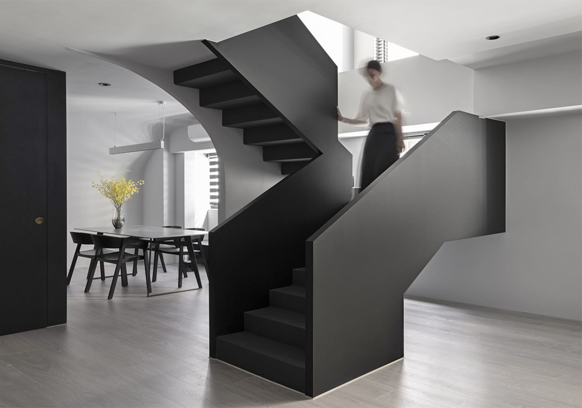 A modern black staircase with a sleek, minimalist design.