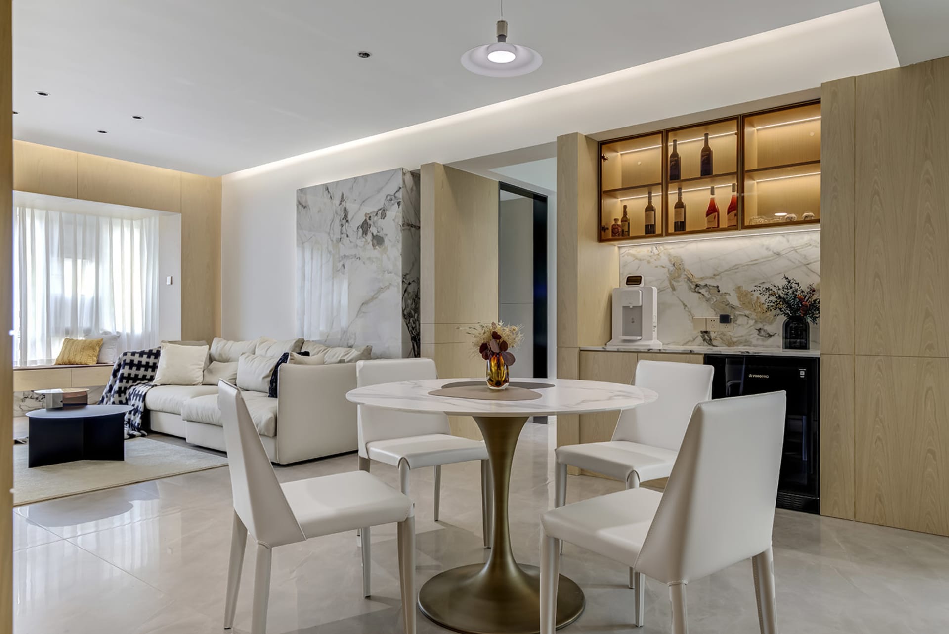 Modern residential space featuring marble and concrete finishes with minimalist furniture and lighting.