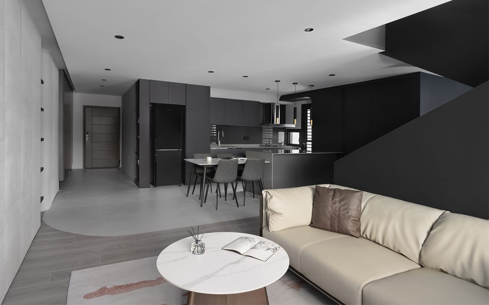 A modern minimalist living room with wood floors, concrete walls, and black furniture.