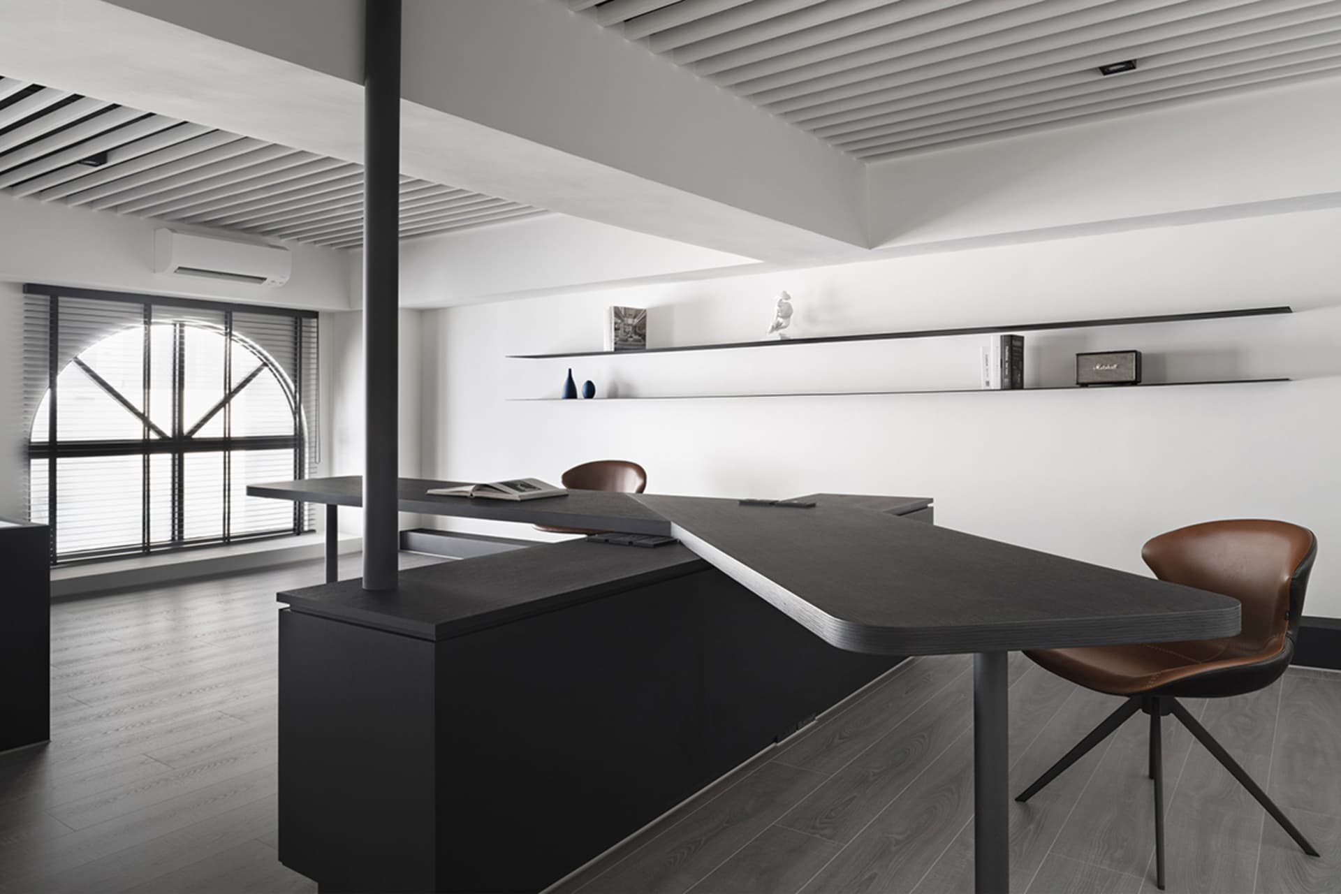 A modern office space featuring a dark wood counter with a sleek, minimalist design.