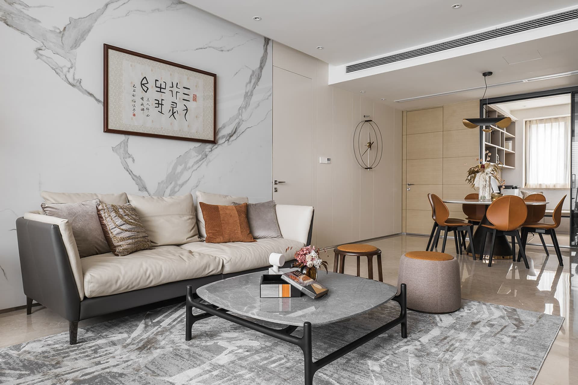 Modern living room featuring a marble sofa, leather accents, and wooden elements
