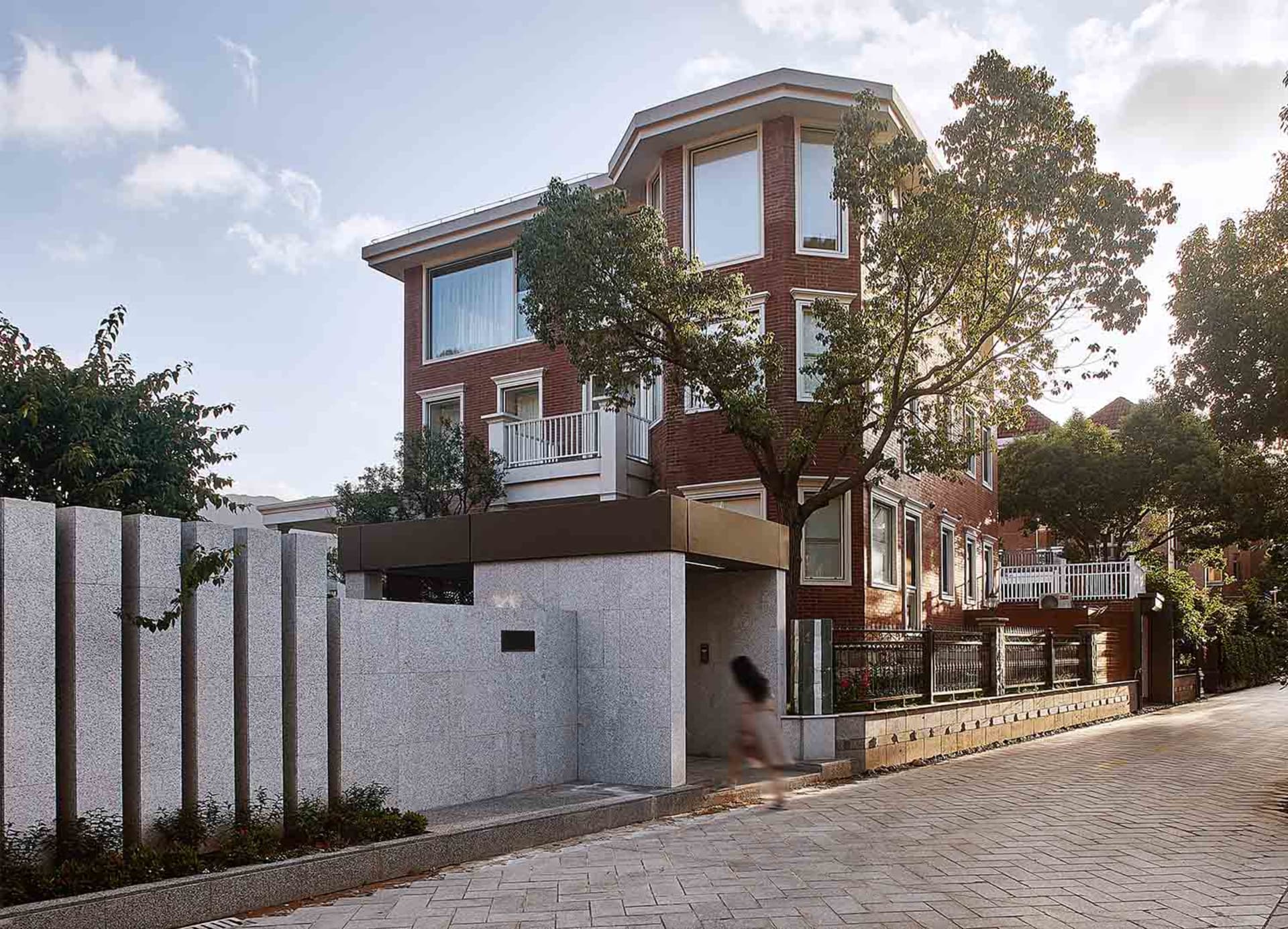 Modern residential exterior showcasing brick and concrete structural elements