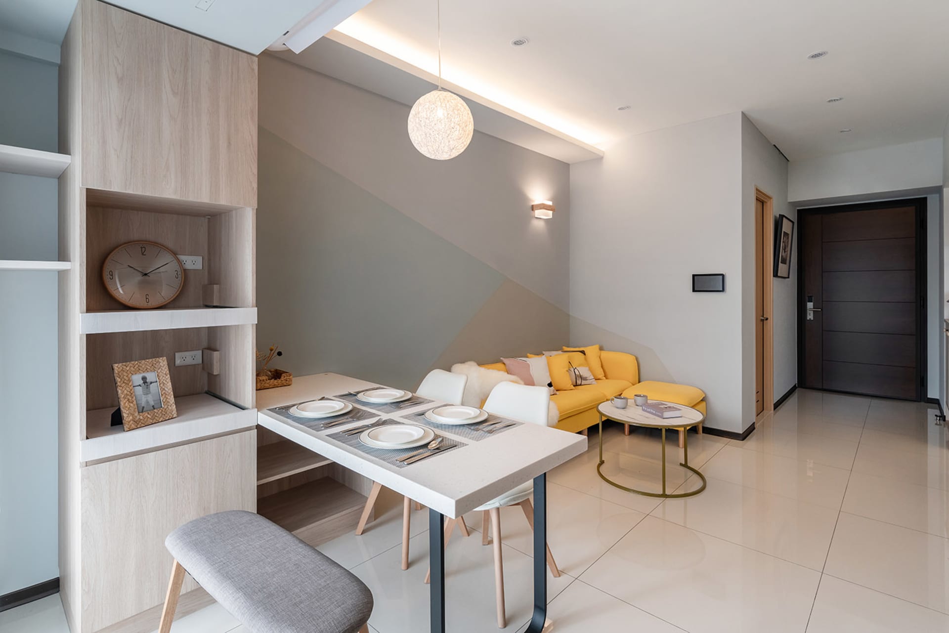Modern living room with wooden furniture, fabric seating, ceramic floor, and metal accents.