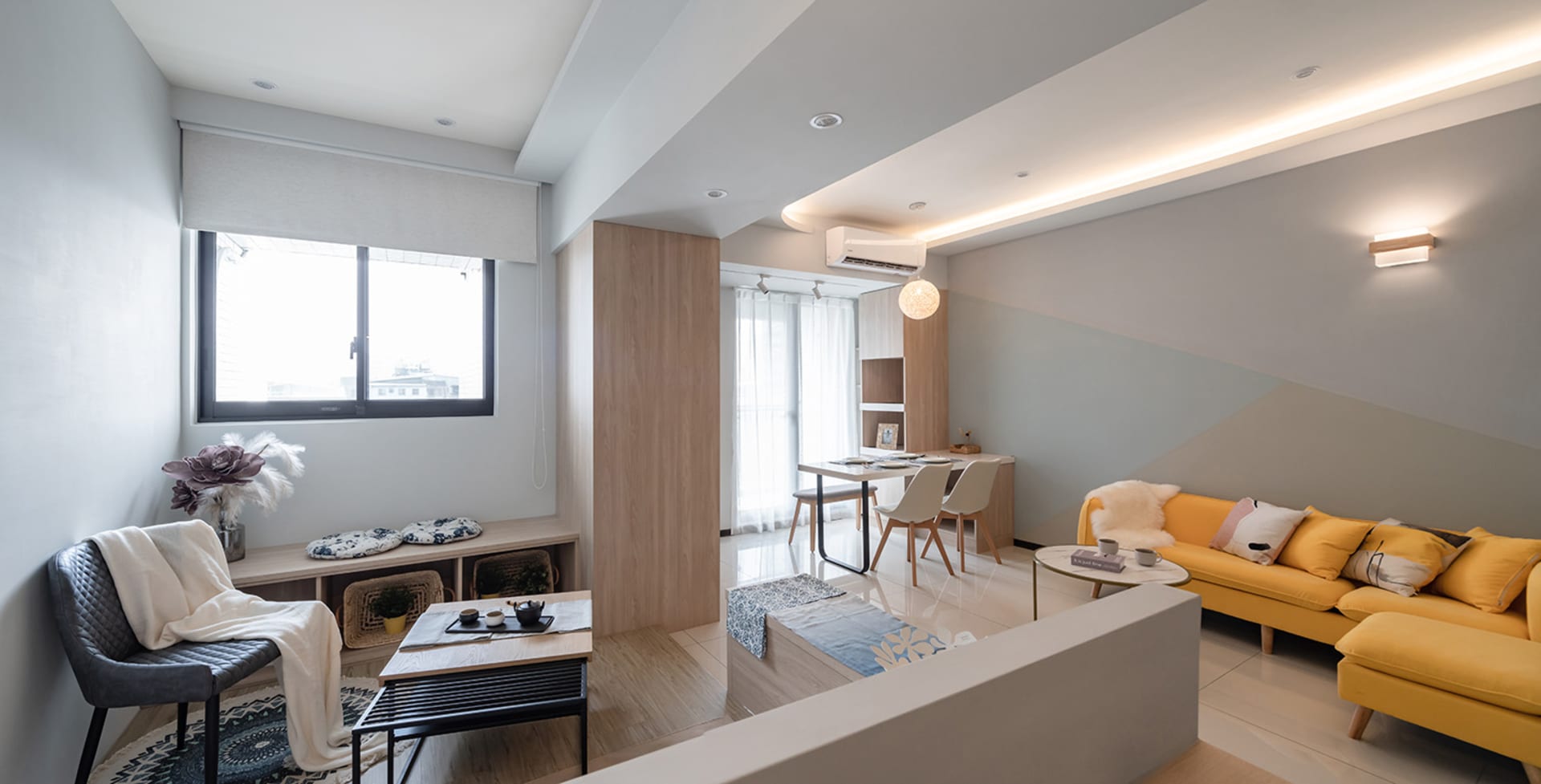 Modern minimalist living room with wooden furniture, leather accents, and textiles