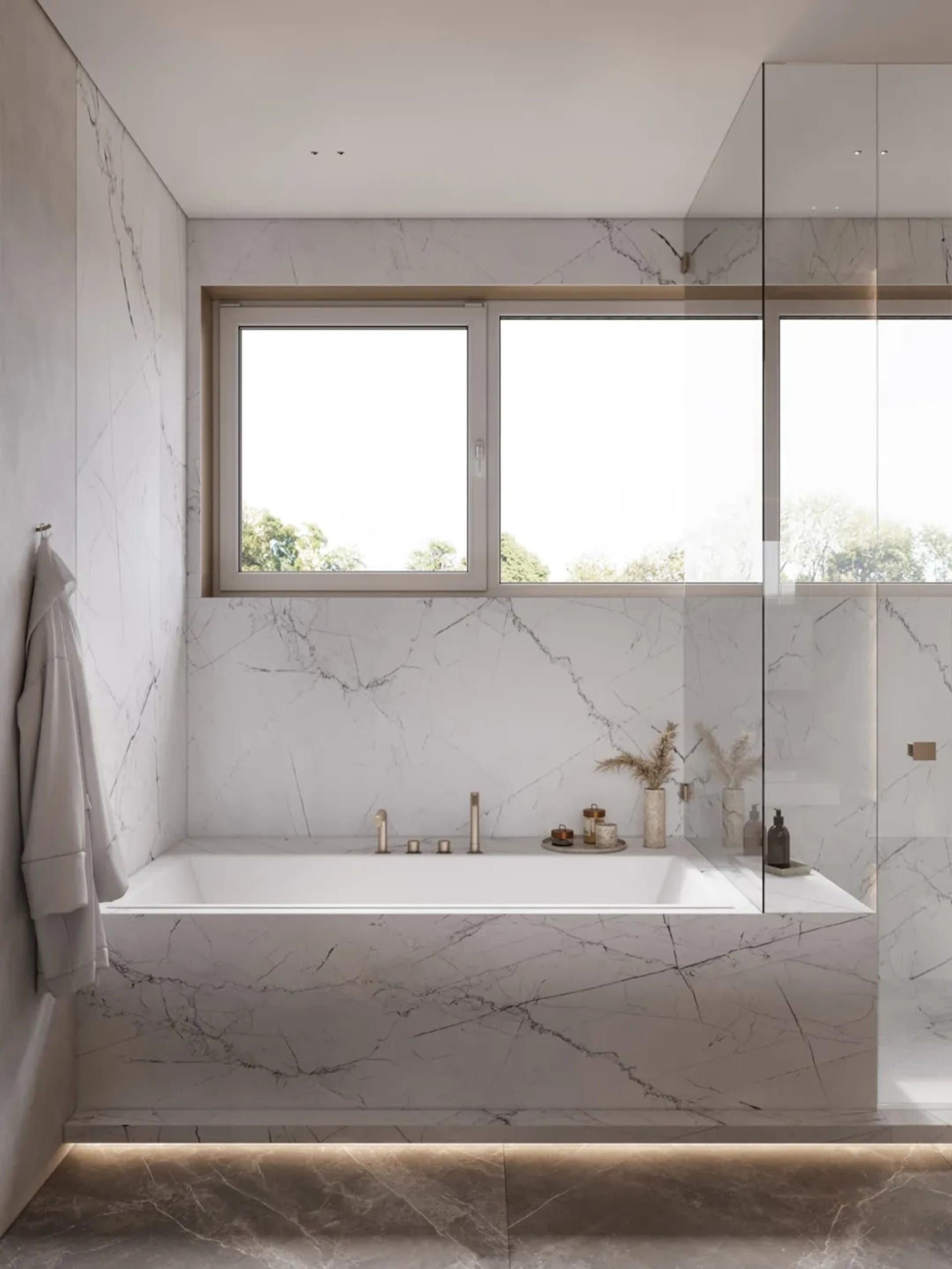 Modern bathroom with marble walls and floor, featuring a bathtub and window.