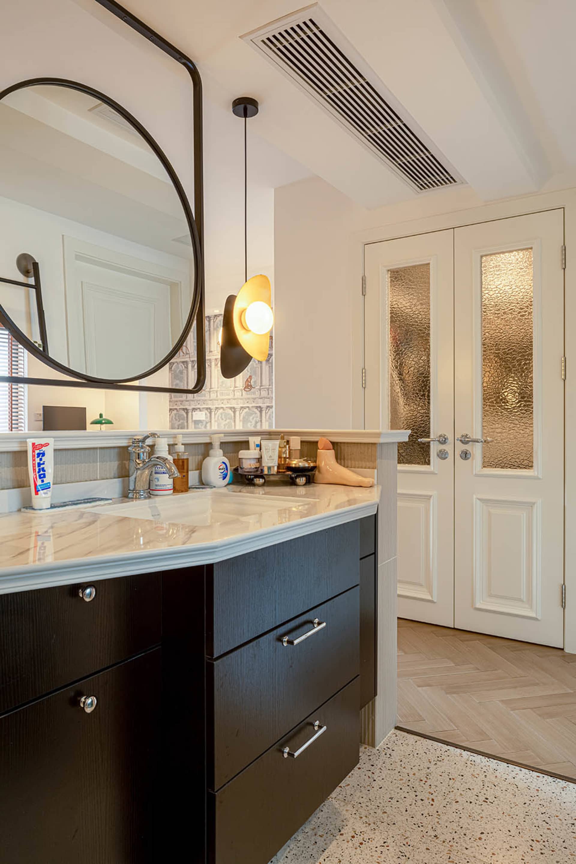 Modern bathroom featuring a marble countertop and sleek, minimalist design.