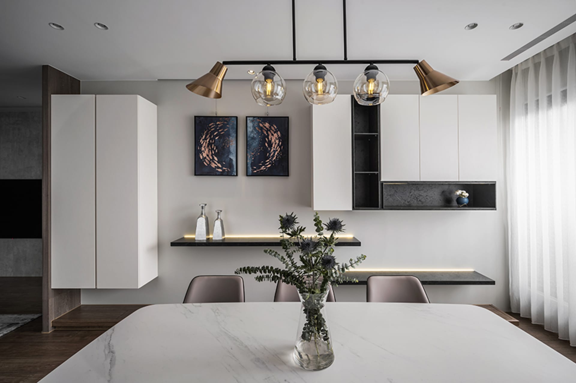 Minimalist modern dining room with white table, black shelving, and wood accents