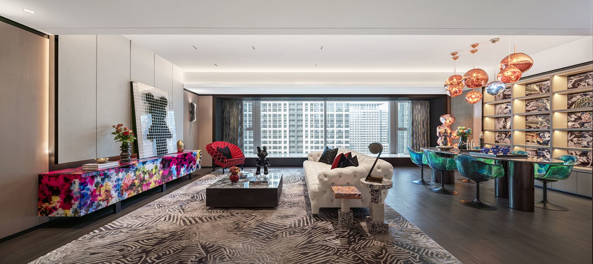 A modern living room featuring colorful furniture, a white sofa, and futuristic lighting.