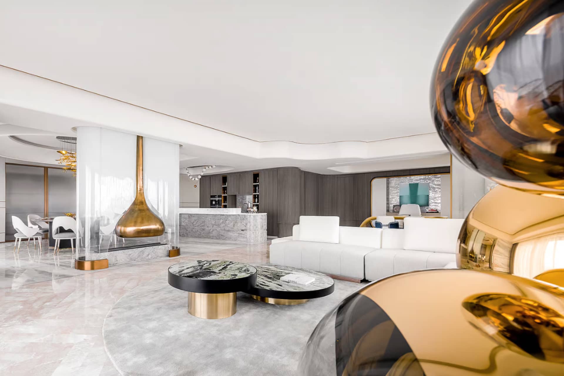 A modern living room featuring marble, black, and gold decor.