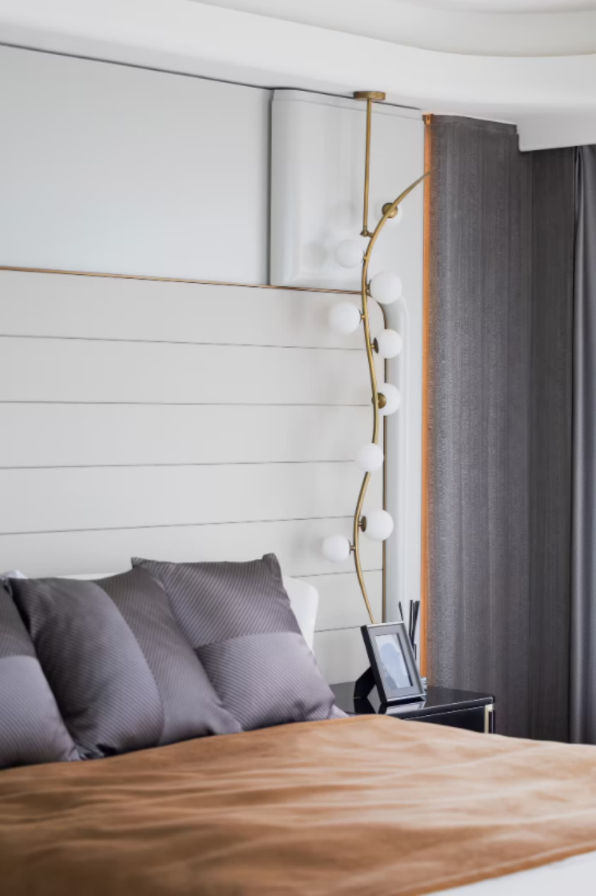 Modern minimalist bedroom with textured white paneled wall