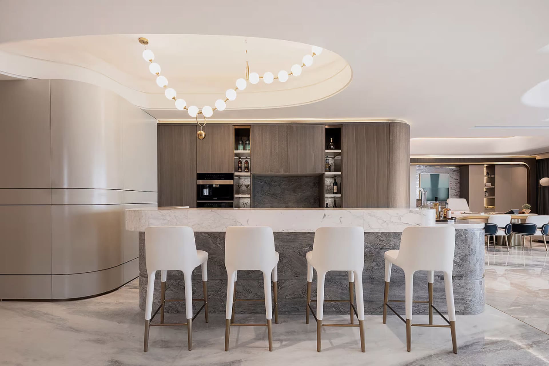 A modern kitchen with white marble countertops and wooden cabinets