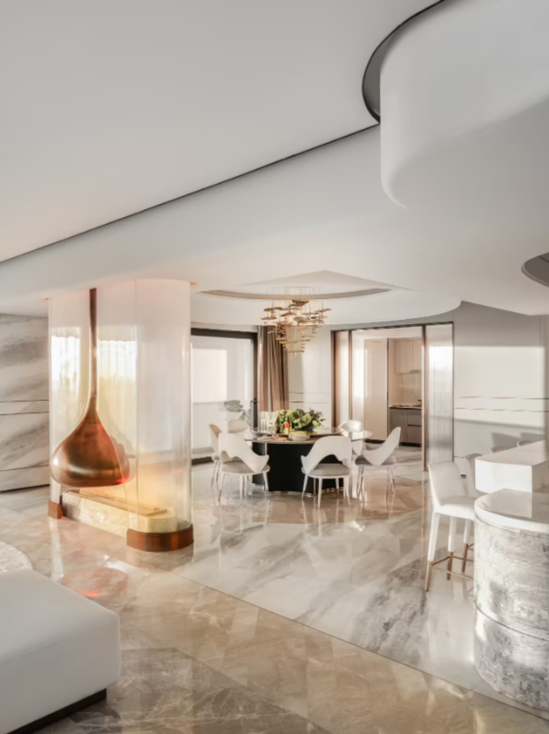 A modern living room featuring marble flooring and a kitchen area with a glass fireplace.