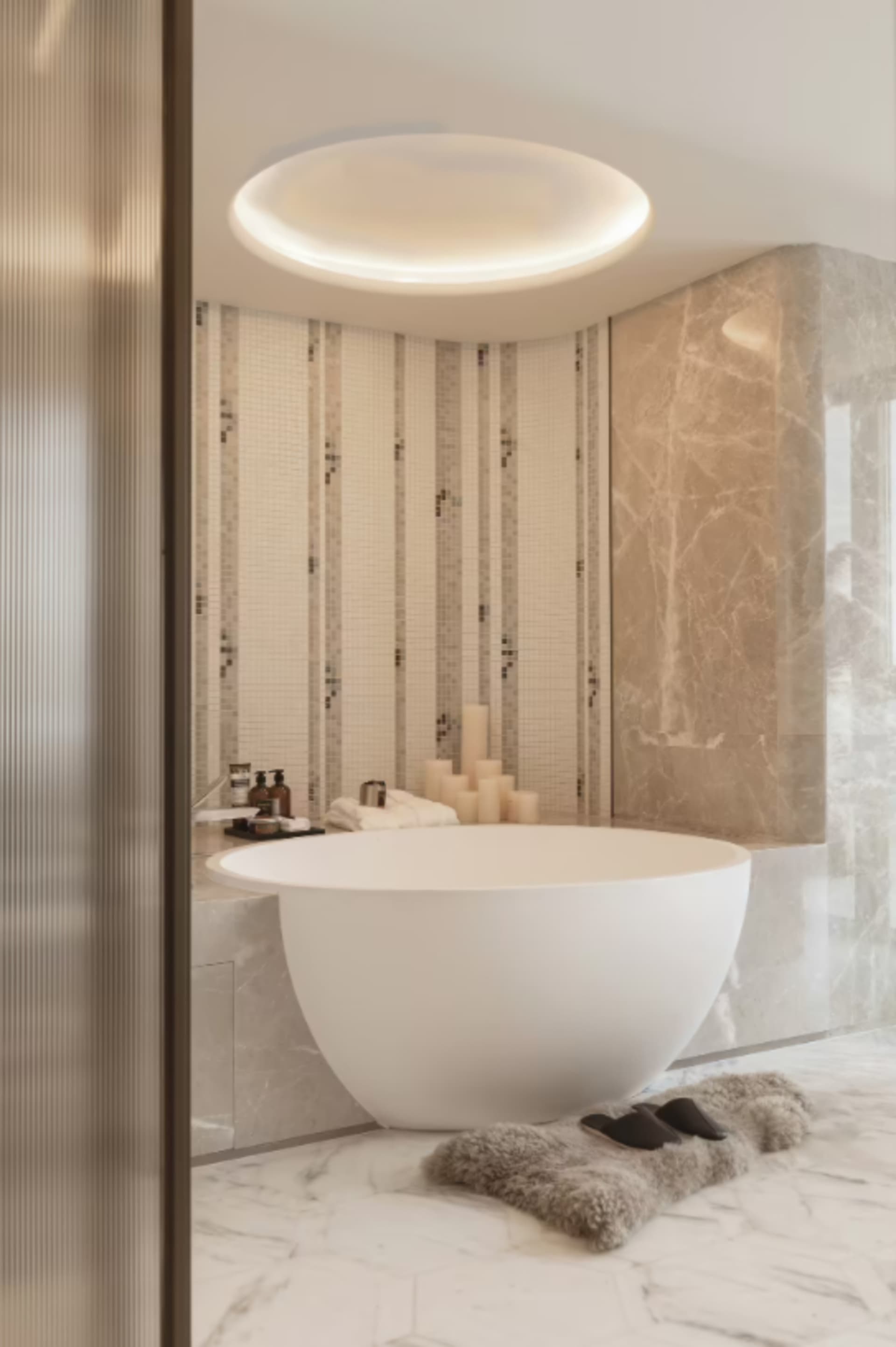 Modern bathroom featuring a freestanding bathtub surrounded by marble tiles and a modern sink with a sleek design.