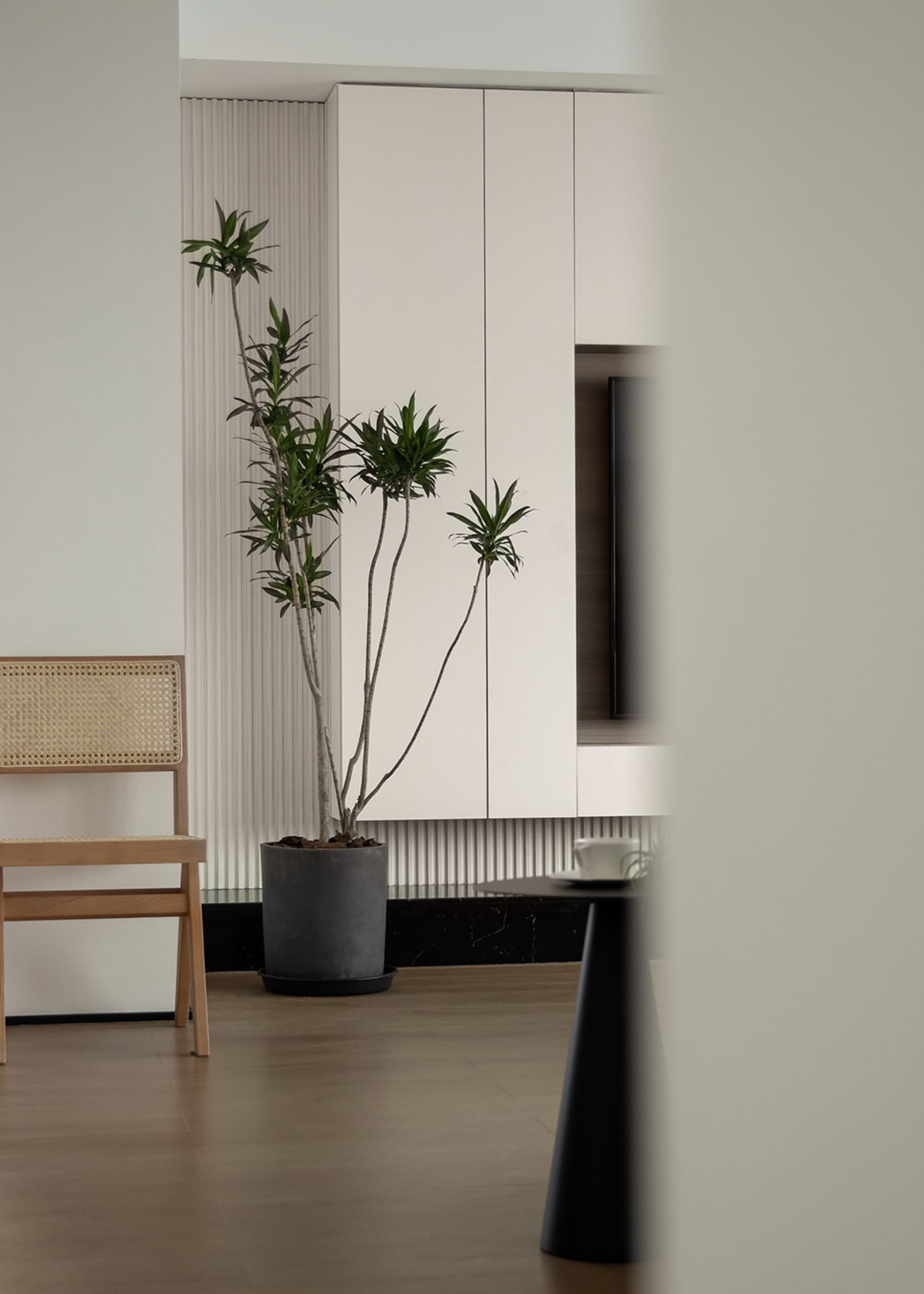 Minimalist living room featuring marble and wood furniture, and concrete flooring.