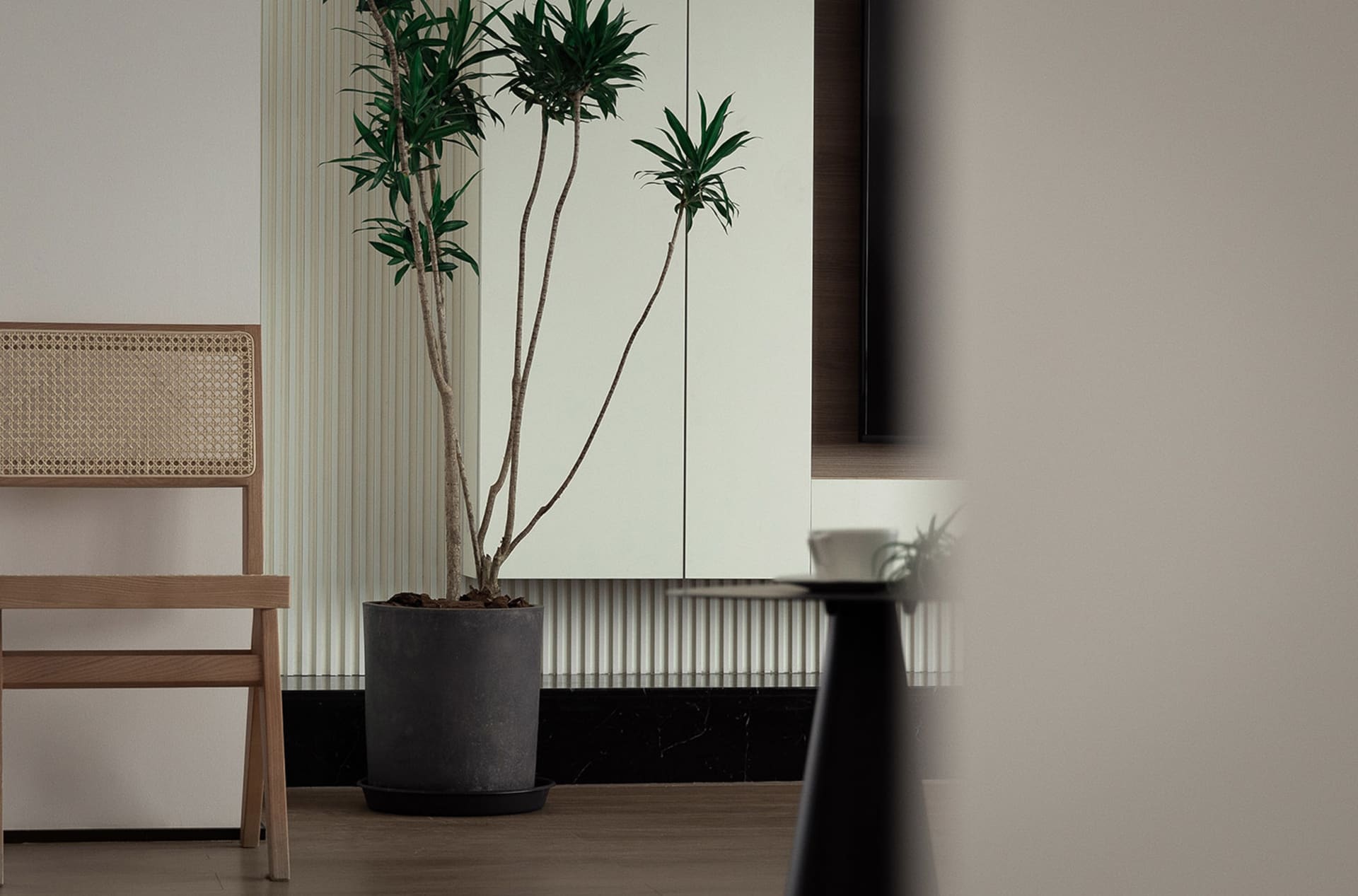 A minimalist living room featuring a modern floating shelf.