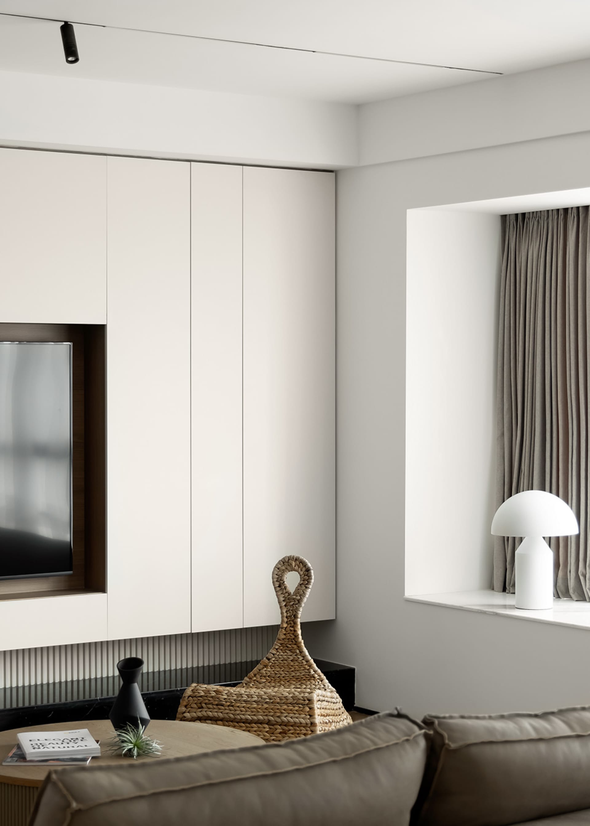Minimalist living room with neutral tones, sleek furniture, and clean lines.
