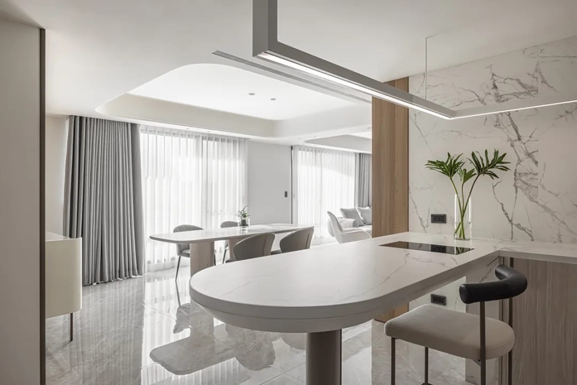 A modern kitchen with marble countertops and wooden accents.