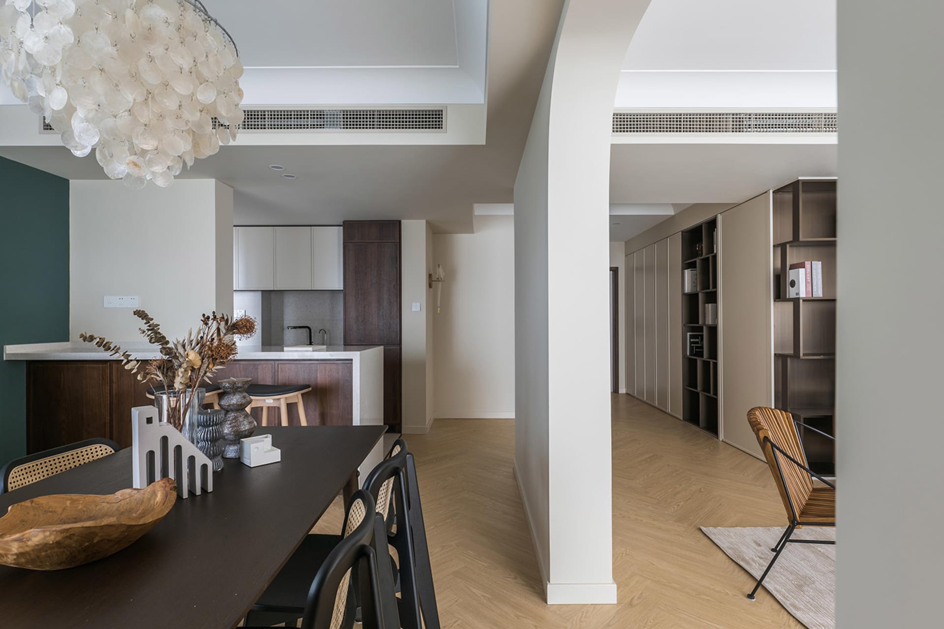 Modern kitchen featuring a wooden dining table and marble countertop.