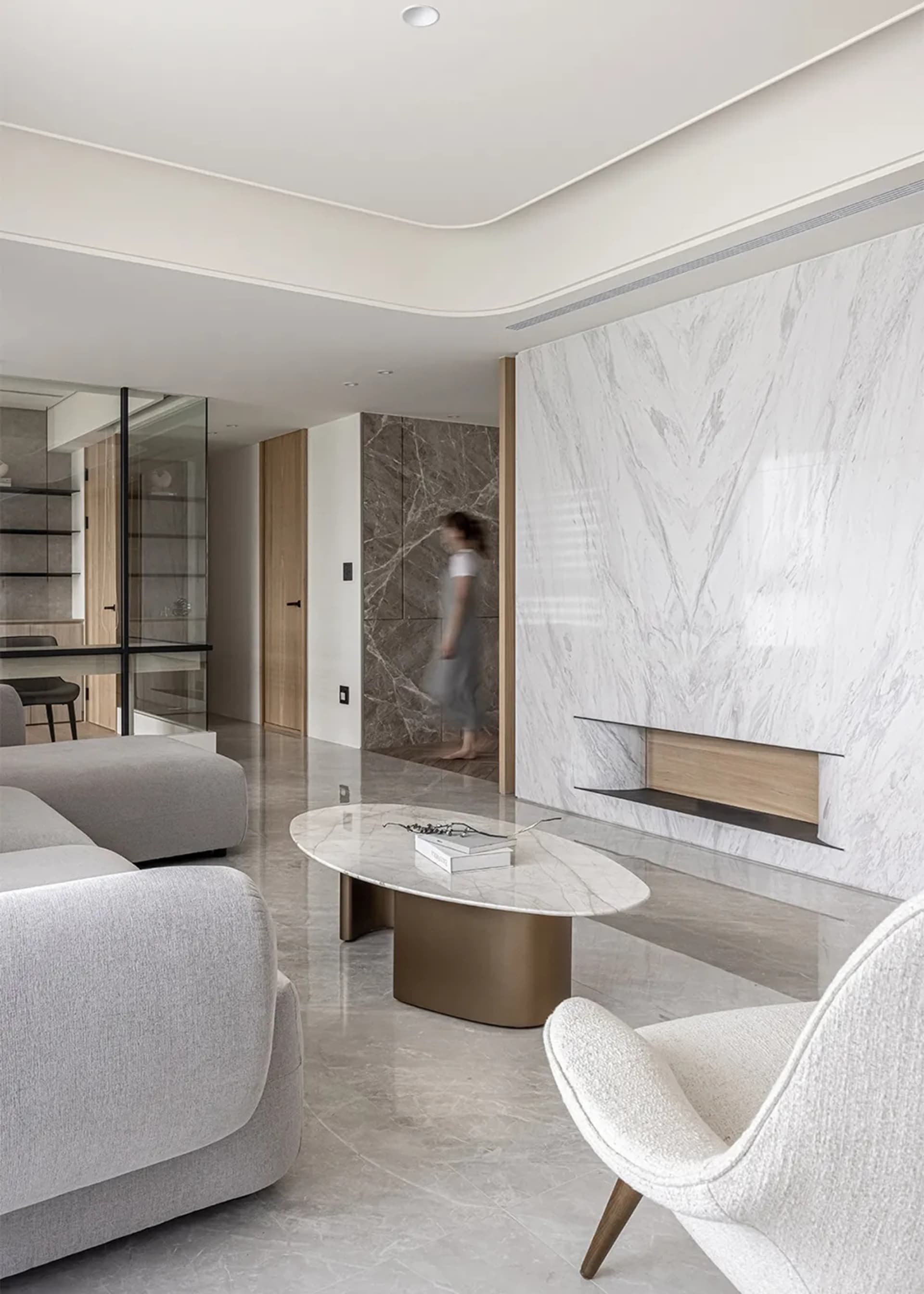Modern minimalist living room with marble floor and furniture, featuring a sleek marble coffee table.