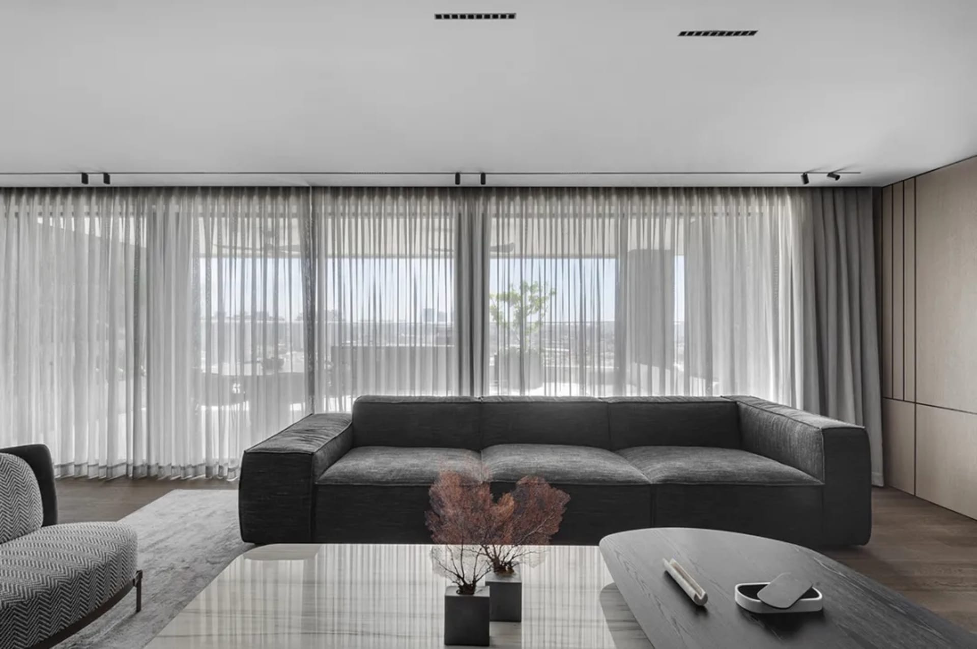 Minimalist living room featuring a textured canvas sofa and wooden table.