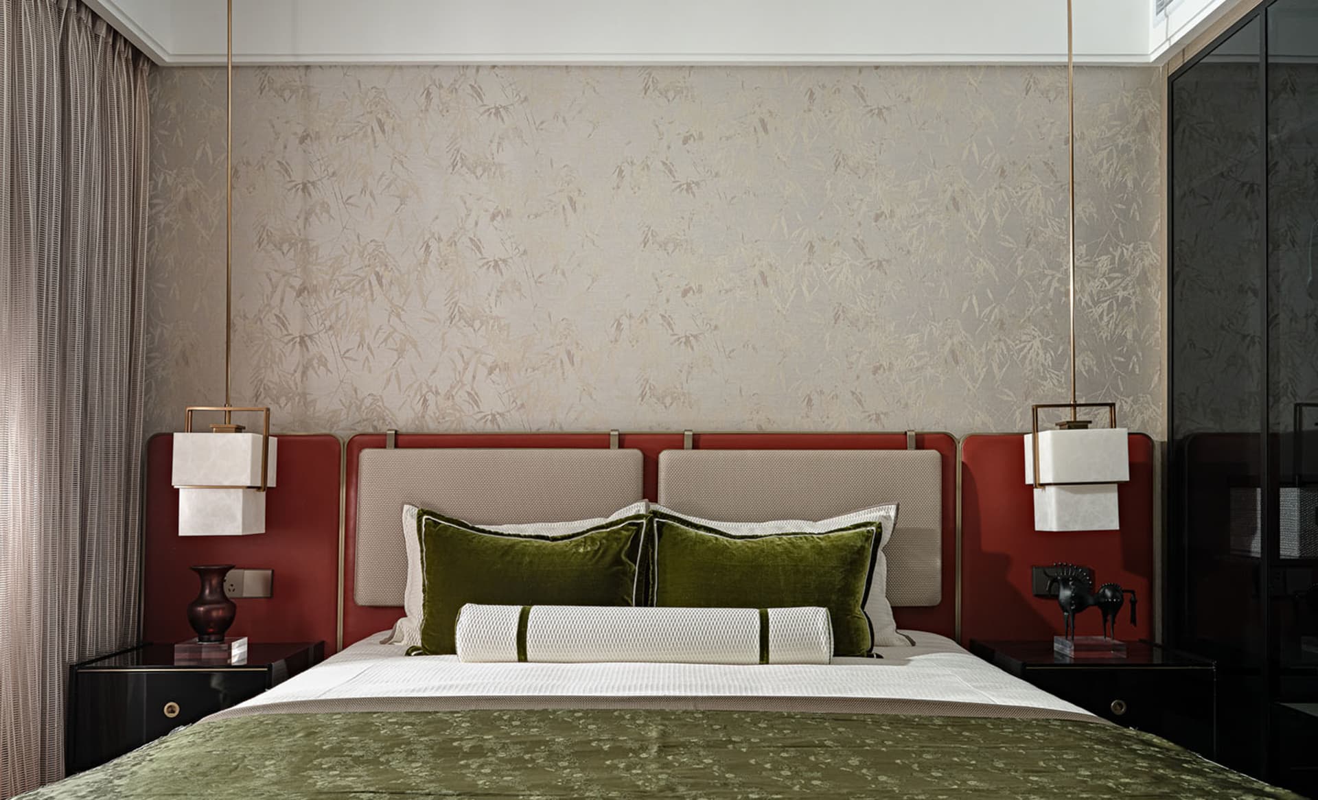 A modern bedroom featuring a velvet headboard and plush bedding.