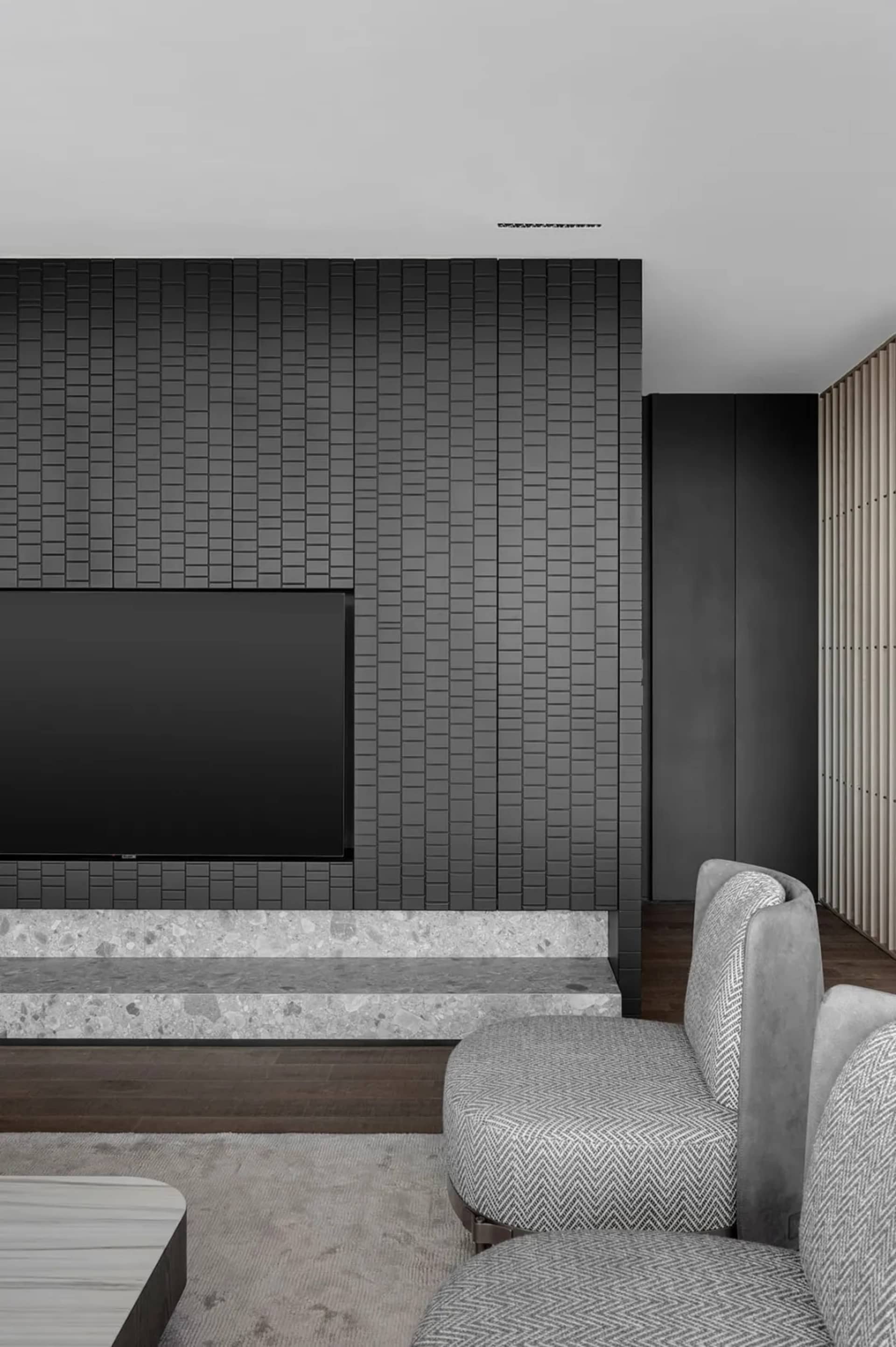 Industrial-style living room featuring concrete walls and marble floor.