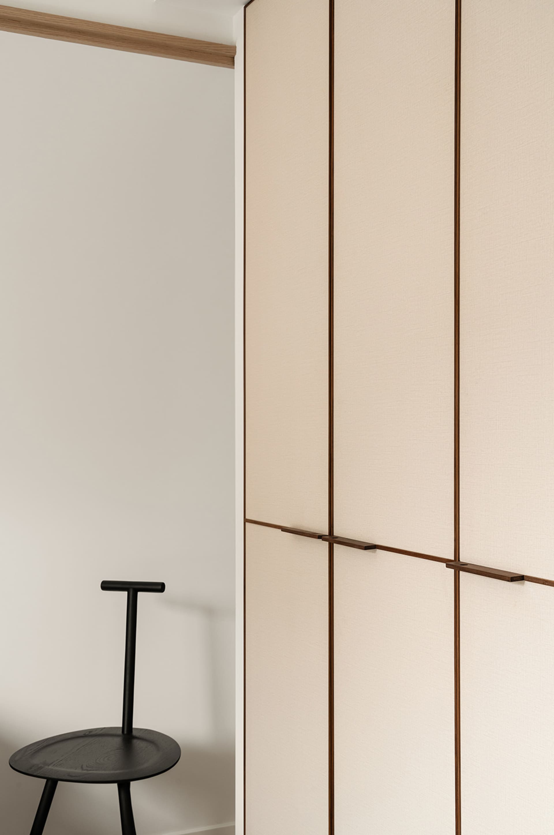 A minimalist wardrobe closed with a fabric door
