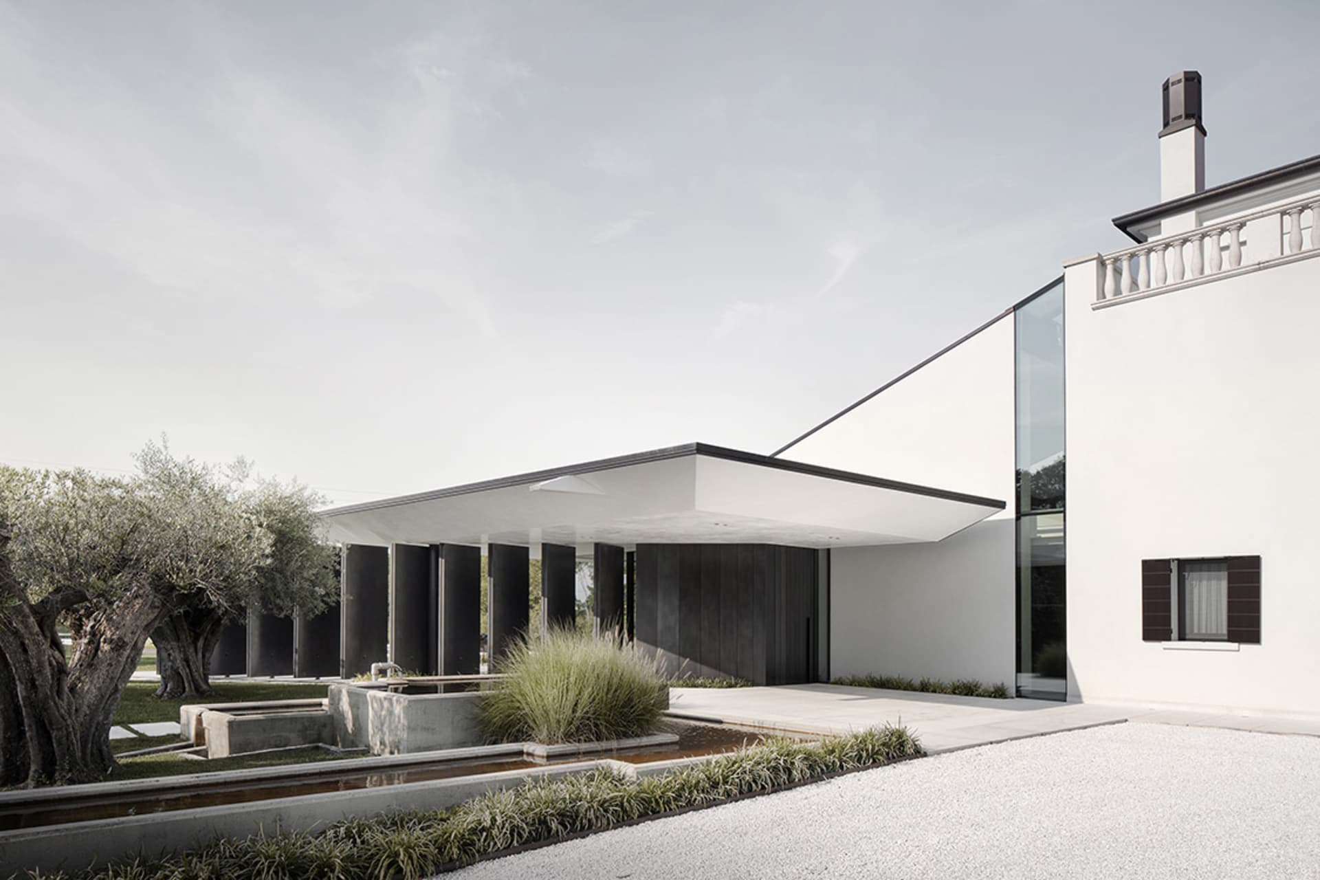 Modern exterior design featuring a minimalist architectural style with concrete and glass materials.