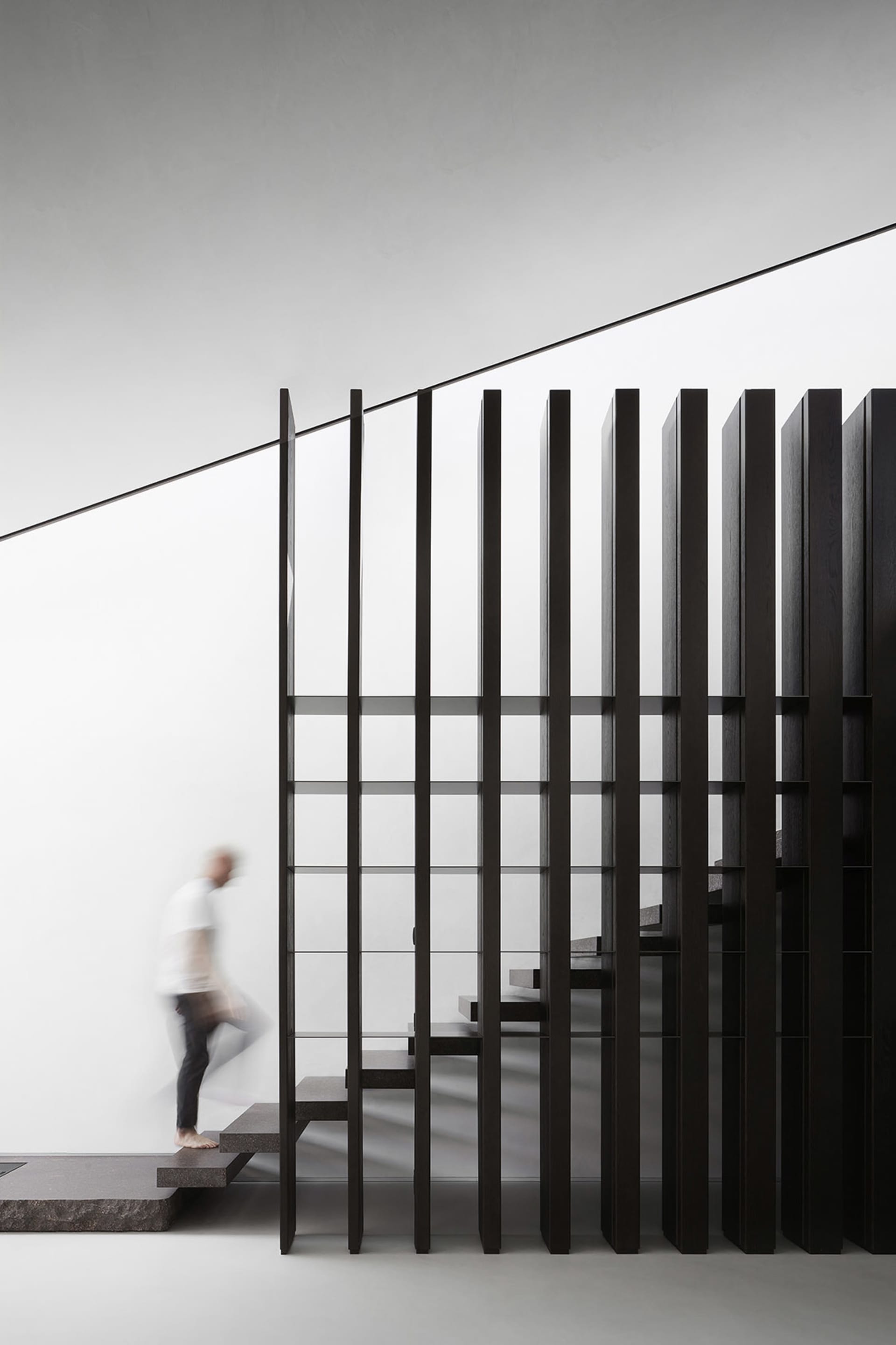 Modern interior staircase featuring glass and metal materials