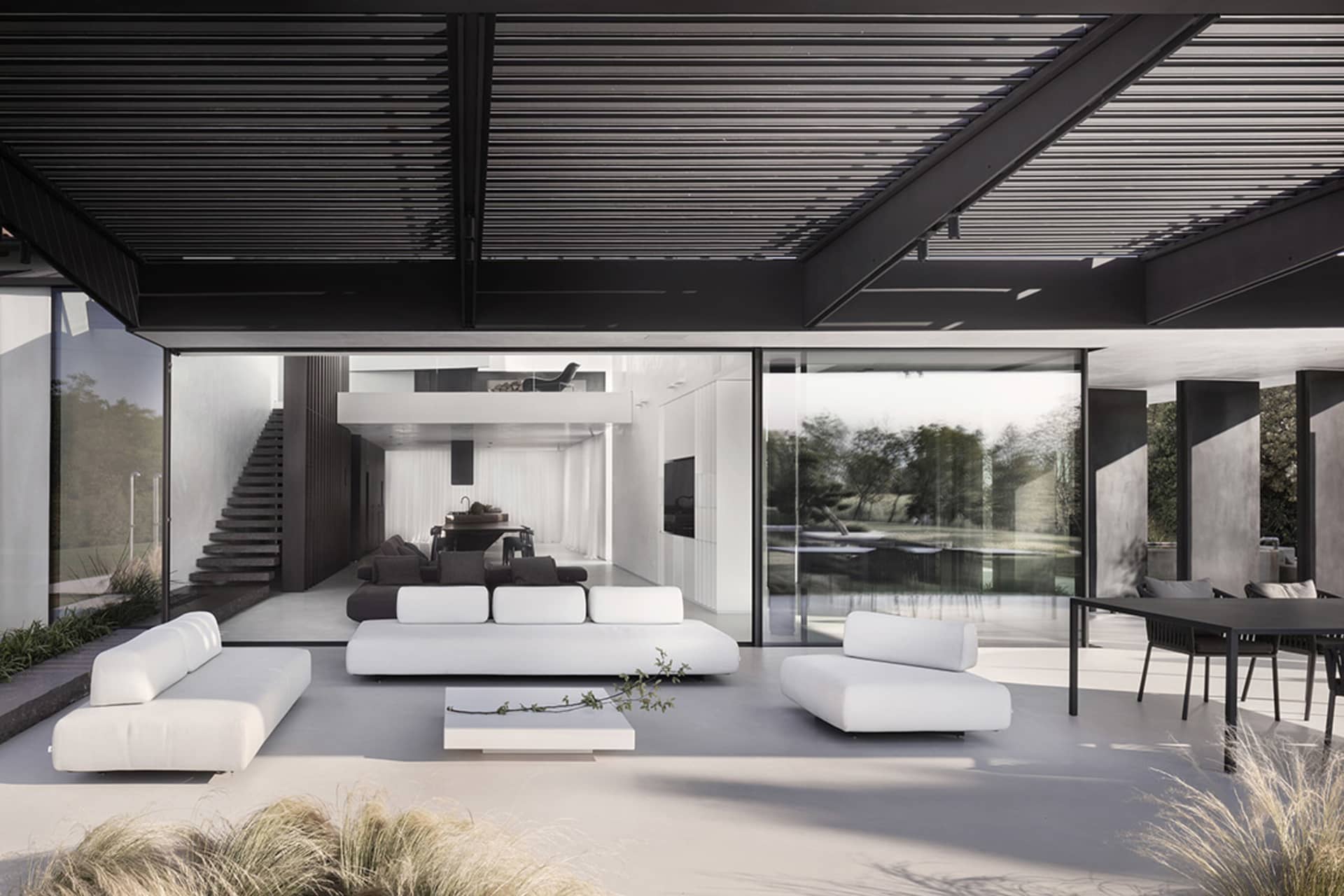 A modern living room with minimalist design and concrete features.